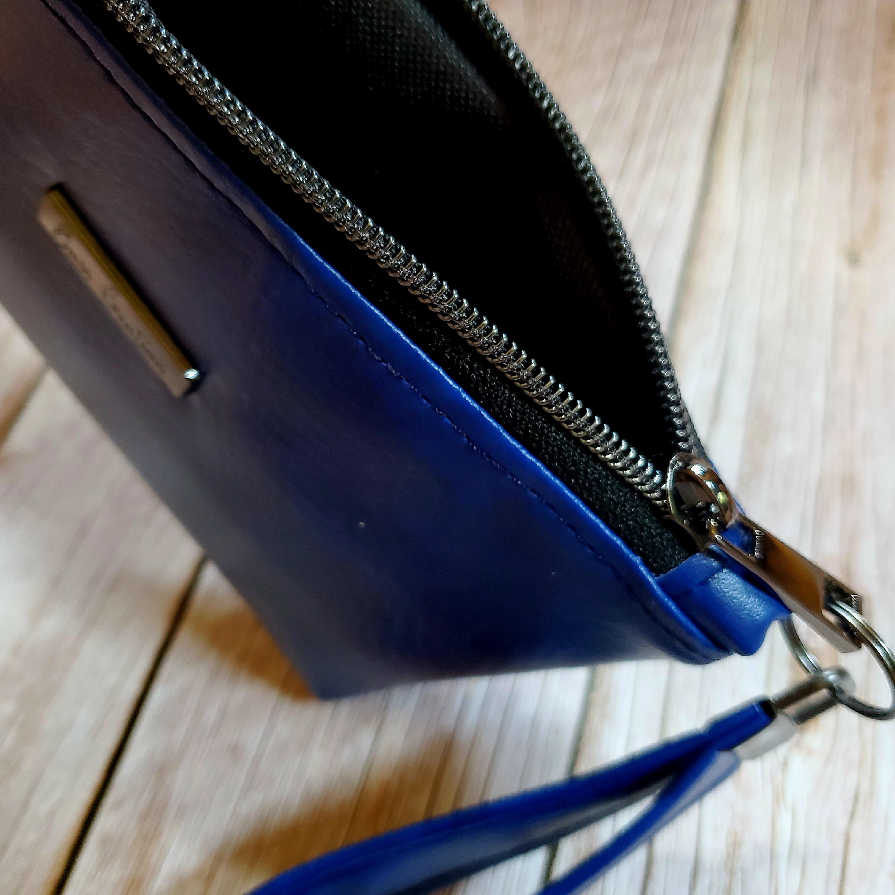 top view of a blue marbled faux leather medium sized makeup bag with gunmetal zipper teeth.