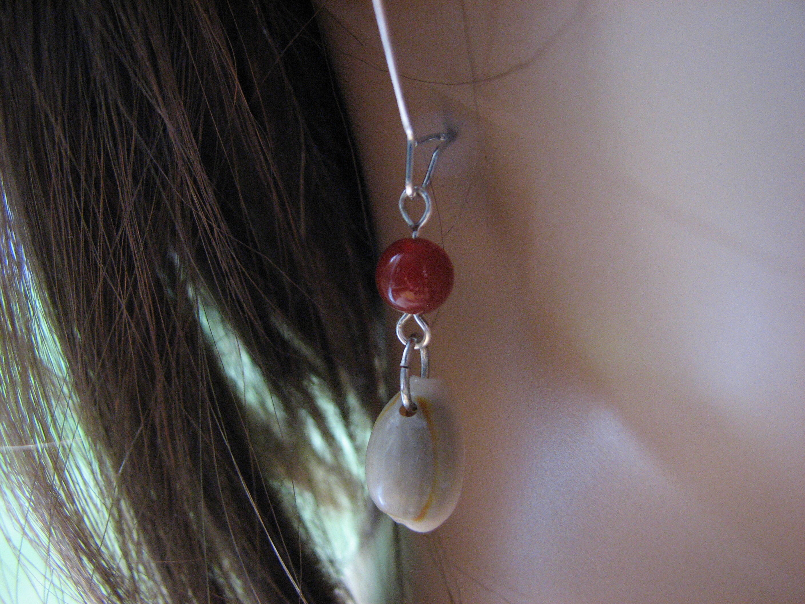 Long kidney shaped hoops with cowrie shell and agate dangles.