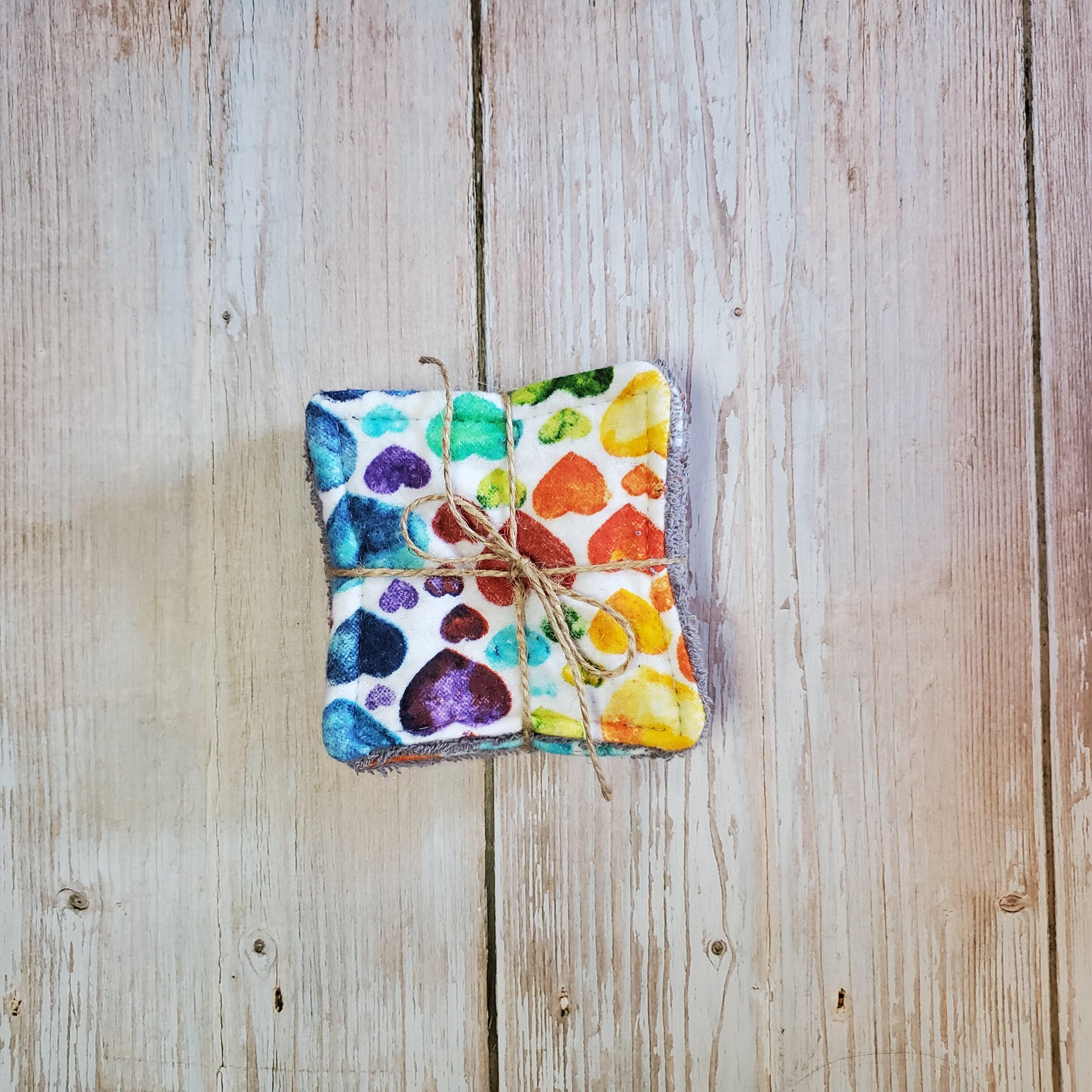 top view of a colorful hearts printed reusable facial square.