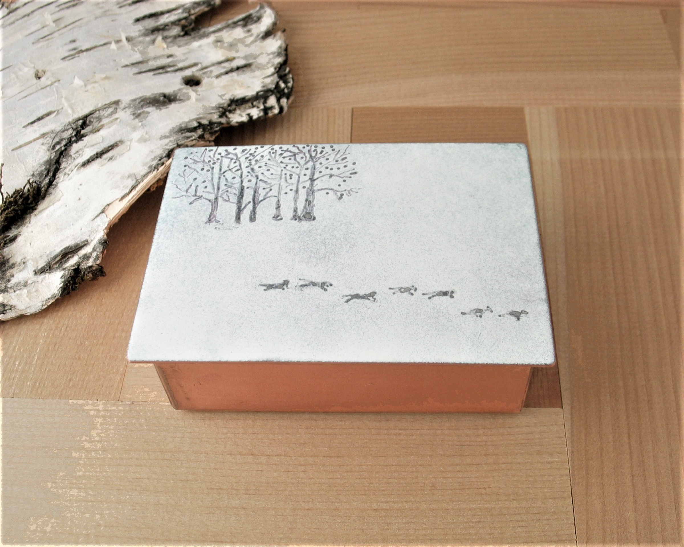 solid copper trinket box 3" x 2" with enameled lid with silhouettes of trees and running wolves