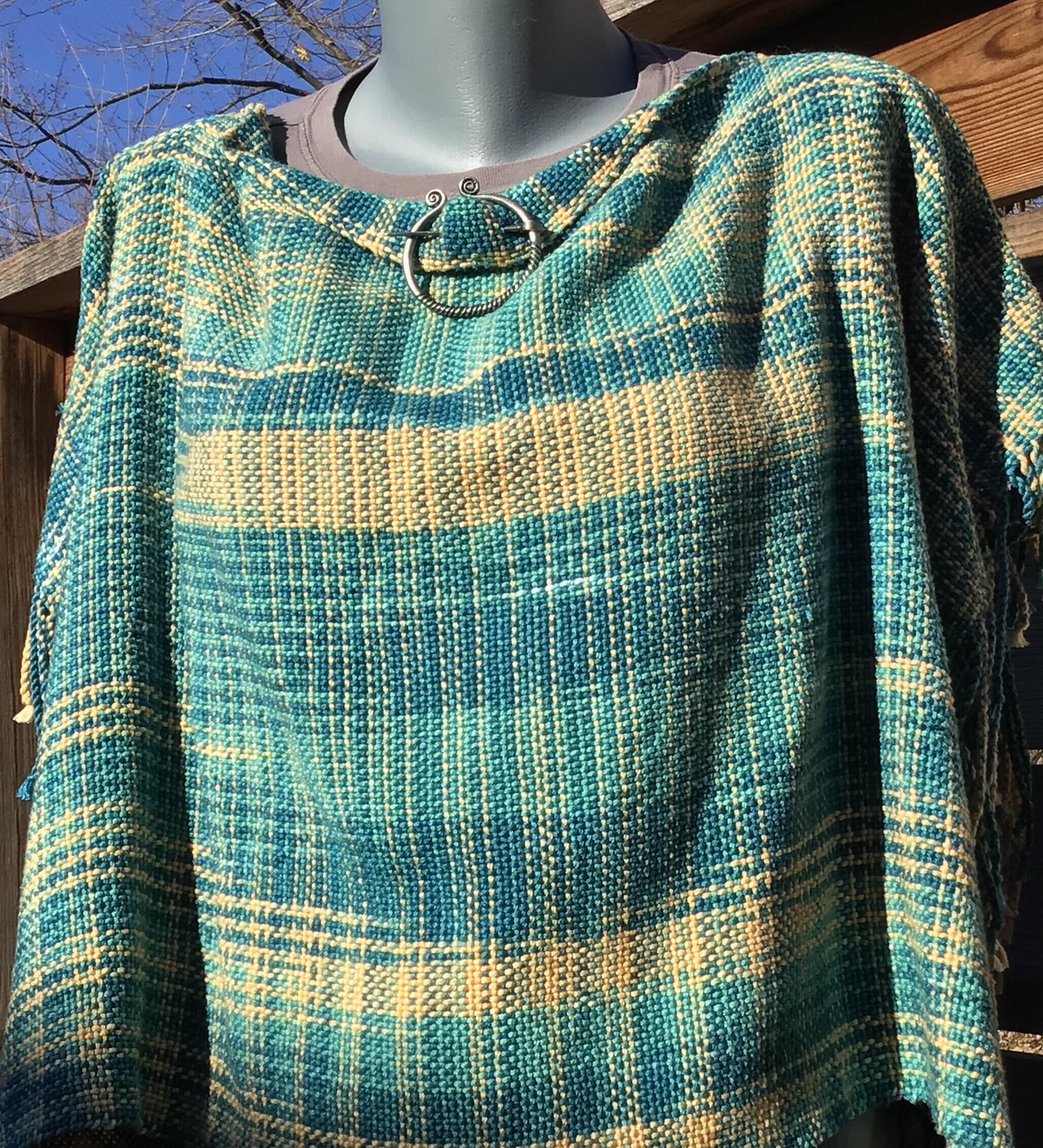 Colorful cropped poncho handwoven in variegated cotton yarn and finished popular with twisted fringe. Ponchette, three season fashion statement.