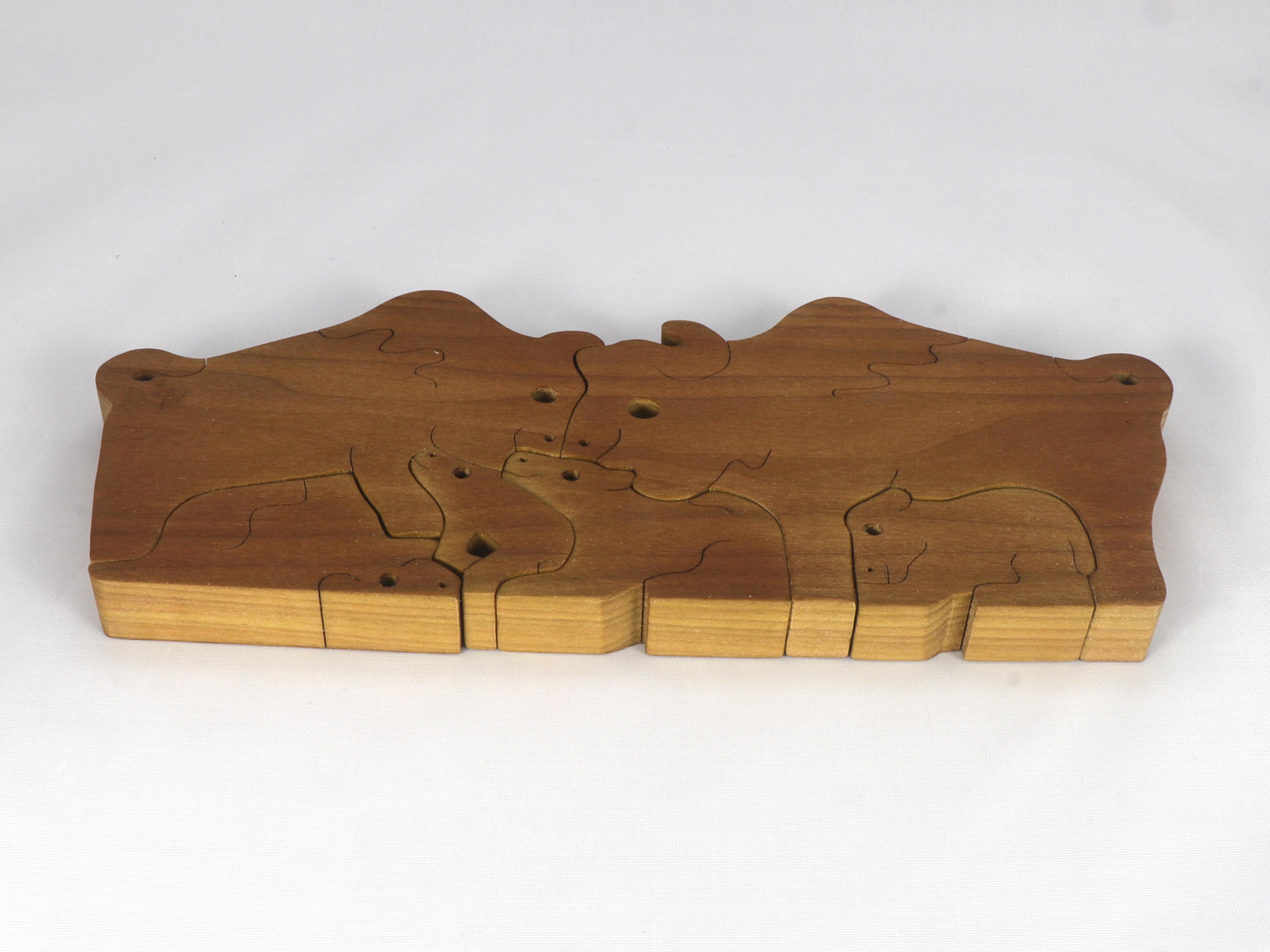 Handmade freestanding buffalo family stacking puzzle made of select-grade hardwoods. Finished with a blend of mineral oil, beeswax, and carnauba wax.