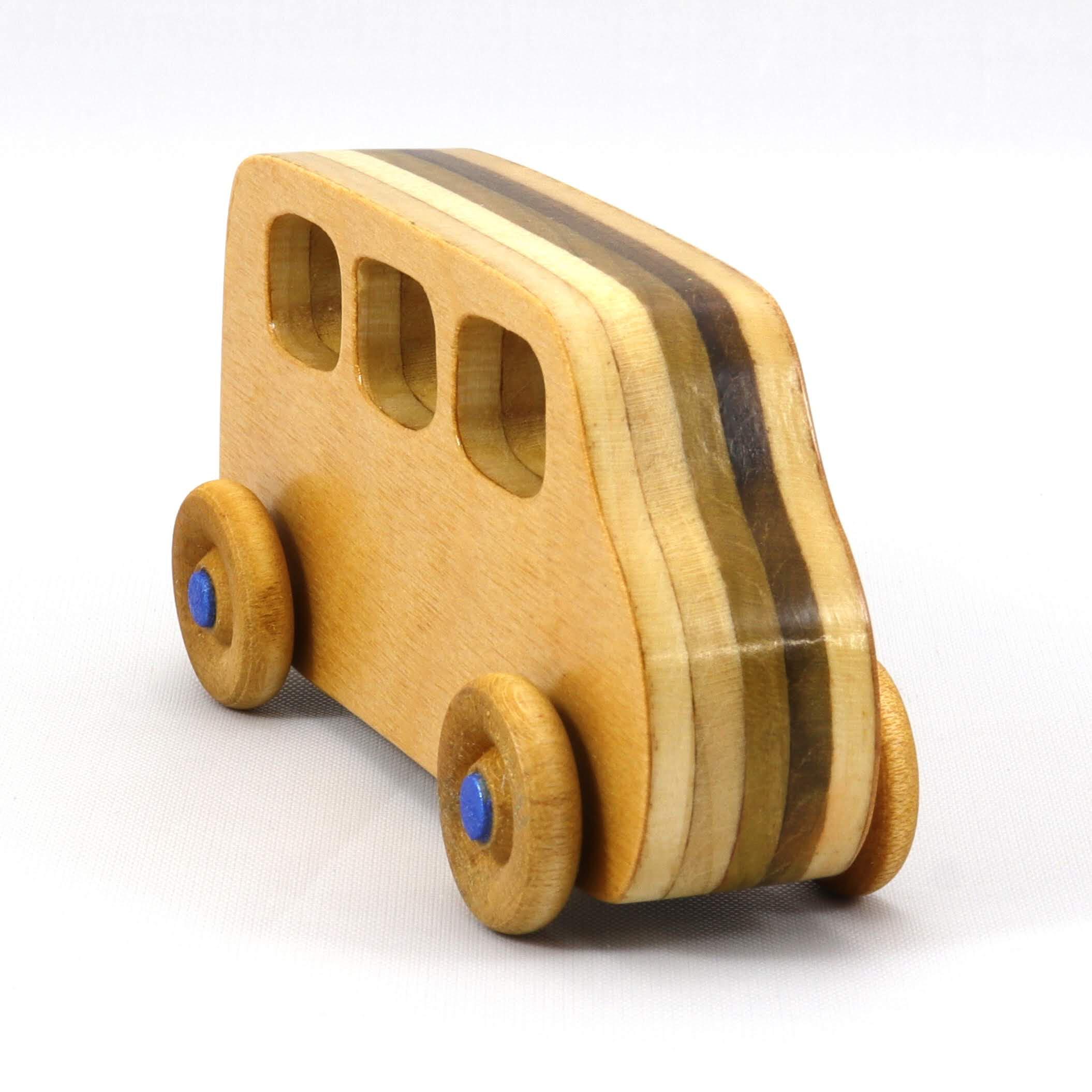 Handmade wood toy minivan made by me in my shop using traditional woodworking tools. It is hand finished with clear shellac with metallic sapphire blue acrylic paint.