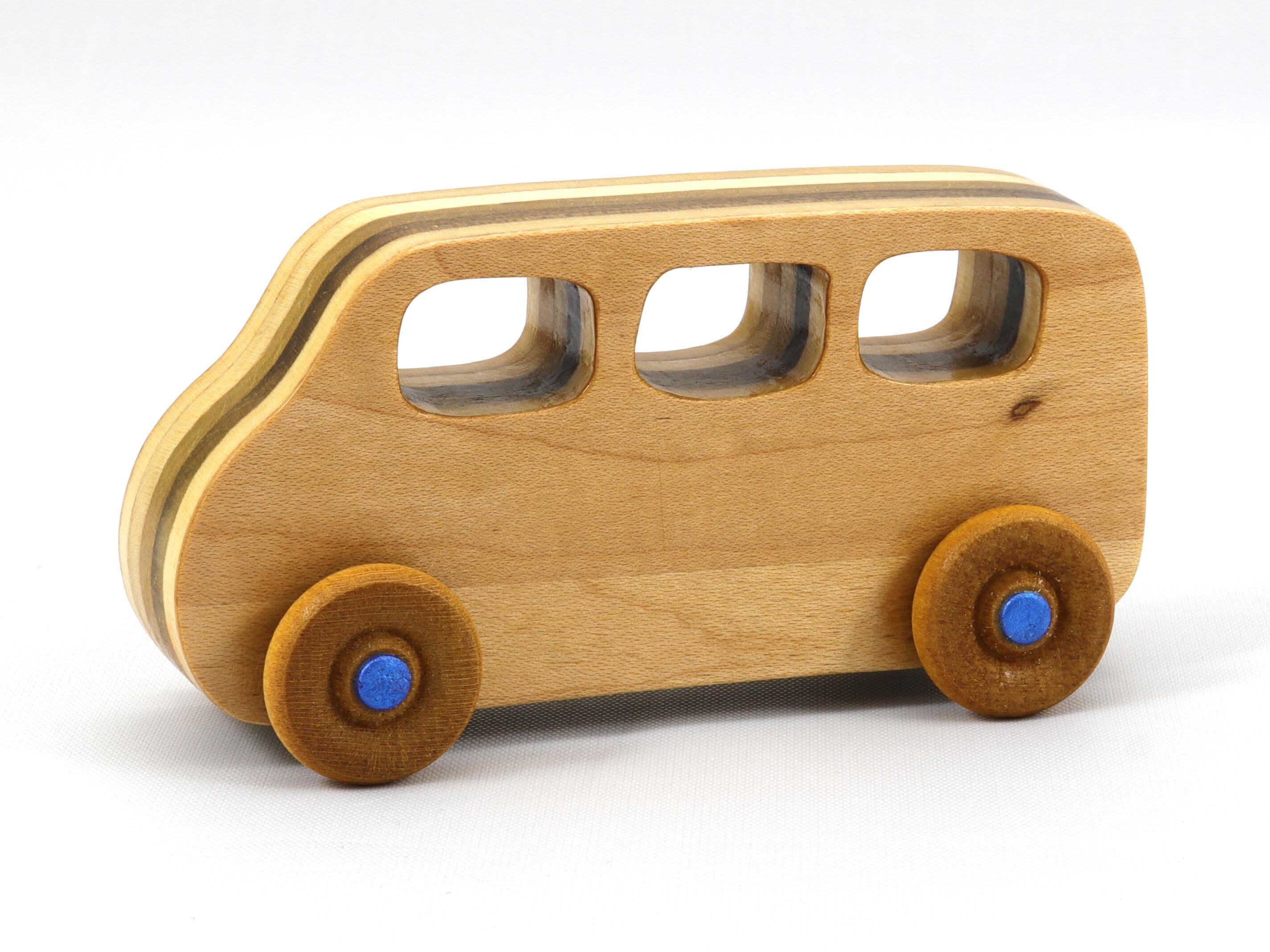 Handmade wood toy minivan made by me in my shop using traditional woodworking tools. It is hand finished with clear shellac with metallic sapphire blue acrylic paint.