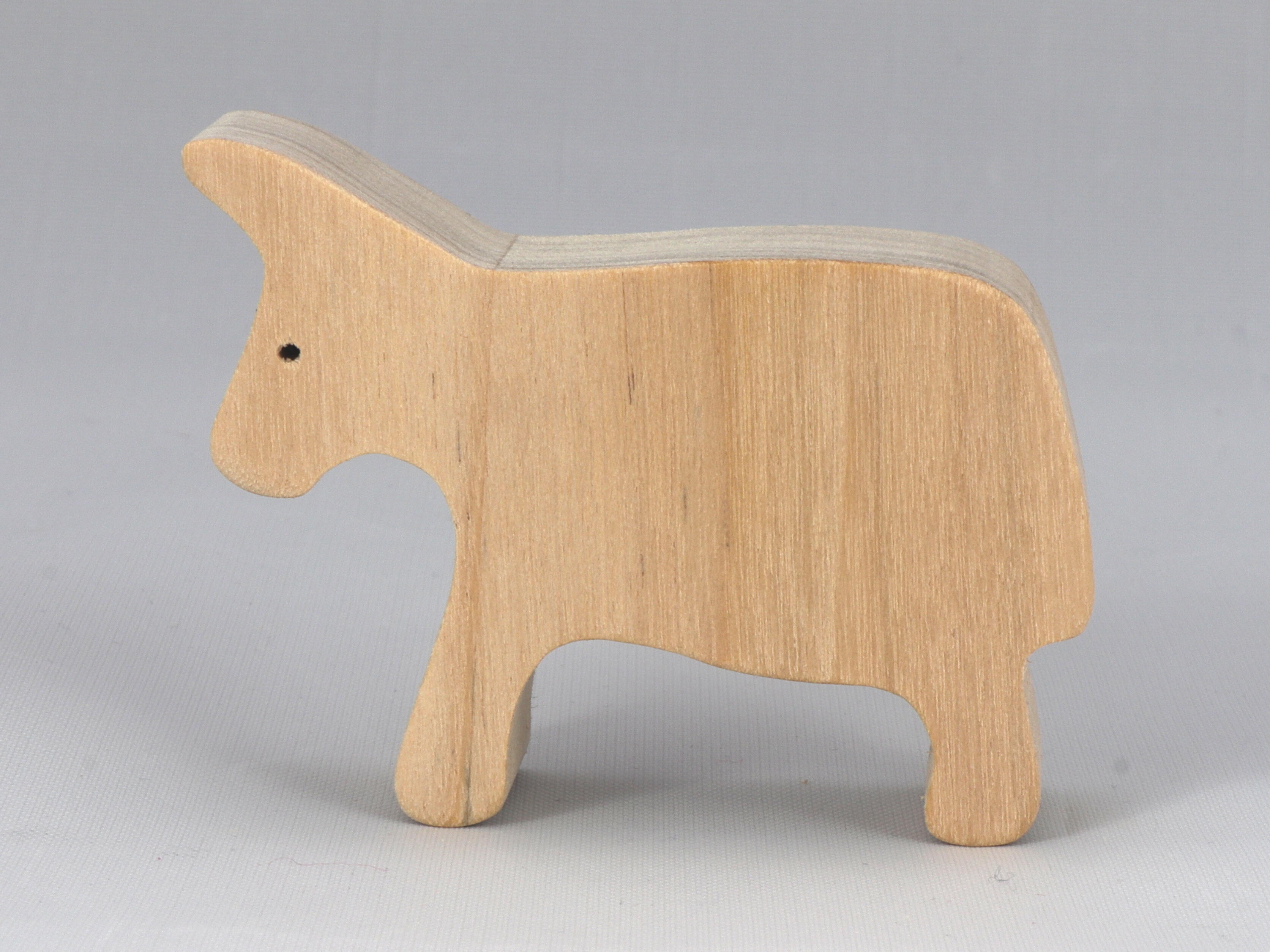 A handmade and unfinished wooden toy cow cutout is perfect for those who love to paint and customize their toys. It is freestanding and stackable, making it a versatile addition to any playroom or nursery. From My Itty Bitty Animal Collection.