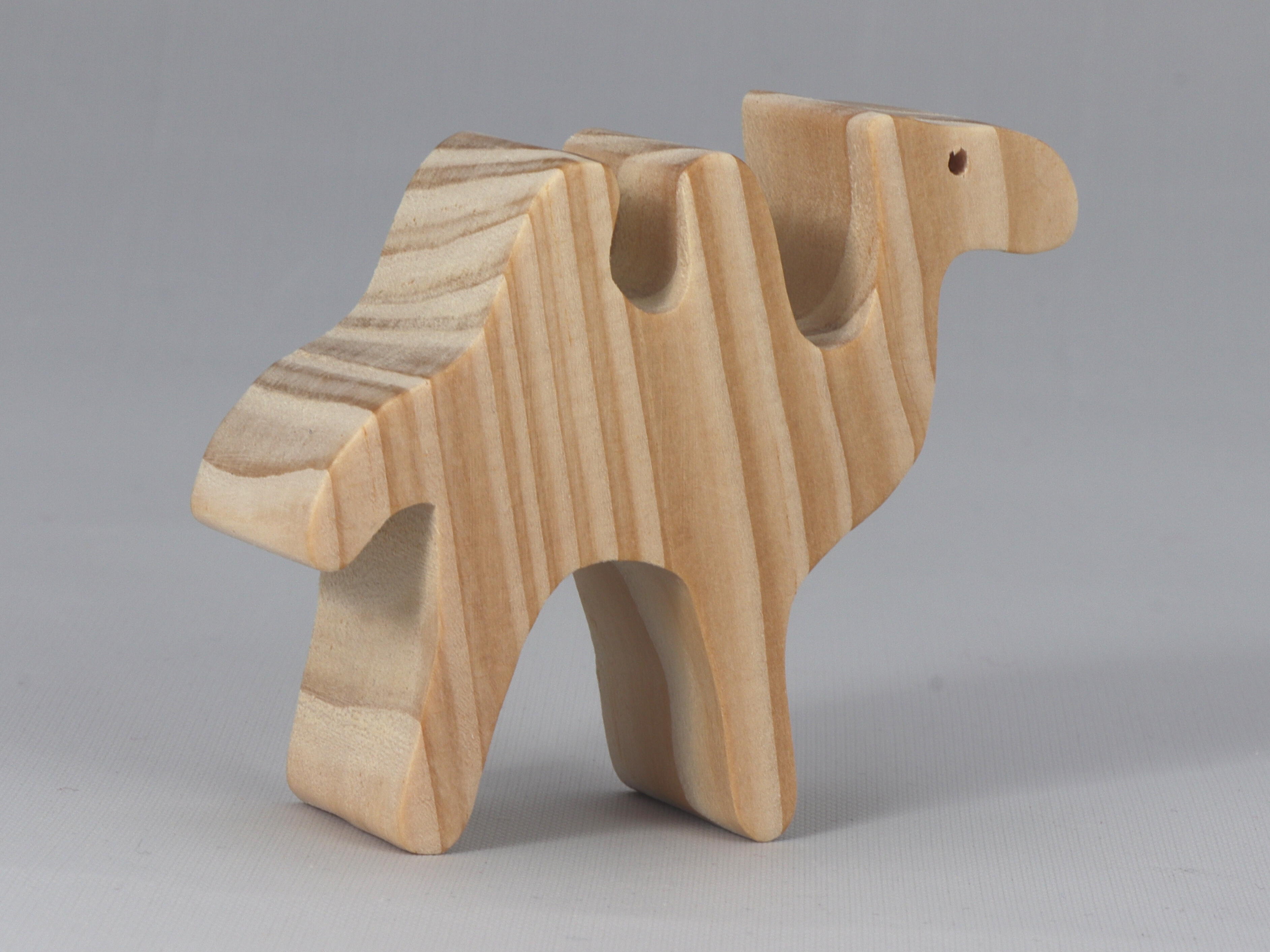 Handmade unfinished wood toy camel from the Itty Bitty Animal Collection sanded smooth and ready to paint. Ideal for kids' crafts or toys, this freestanding camel can be stacked with similar toys for a playful experience.