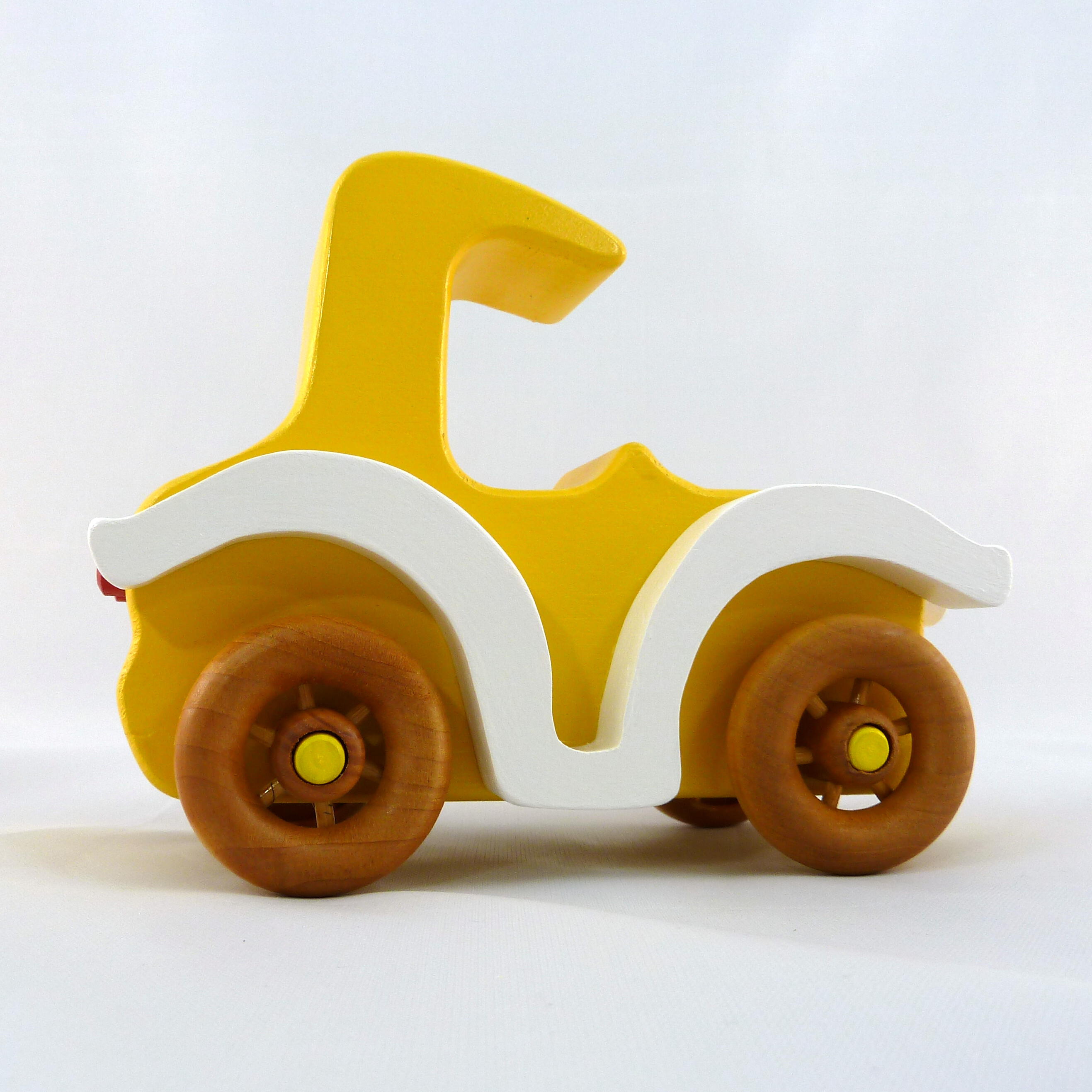 A handmade wooden toy car vintage style coupe painted nontoxic bright yellow and white with spoked wheels finished with nonmarring amber shellac from my  Bad Bobs Custom Motors Collection.