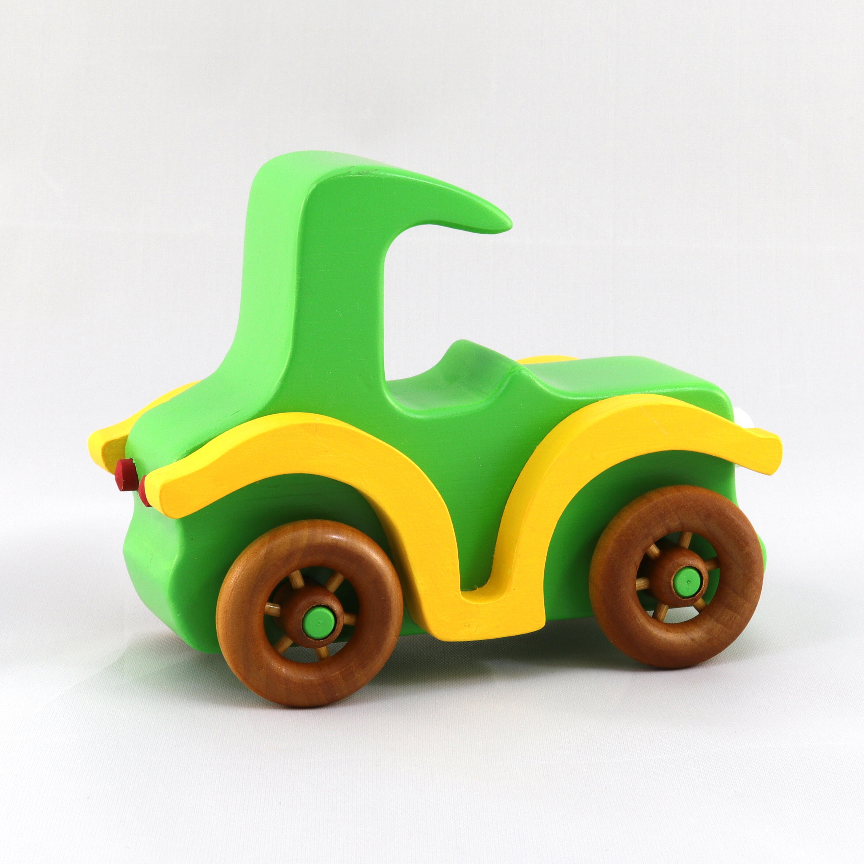 A handmade wooden toy car vintage style coupe painted nontoxic bright green and yellow with spoked wheels finished with nonmarring amber shellac, from my  Bad Bob's Custom Motors Collection.