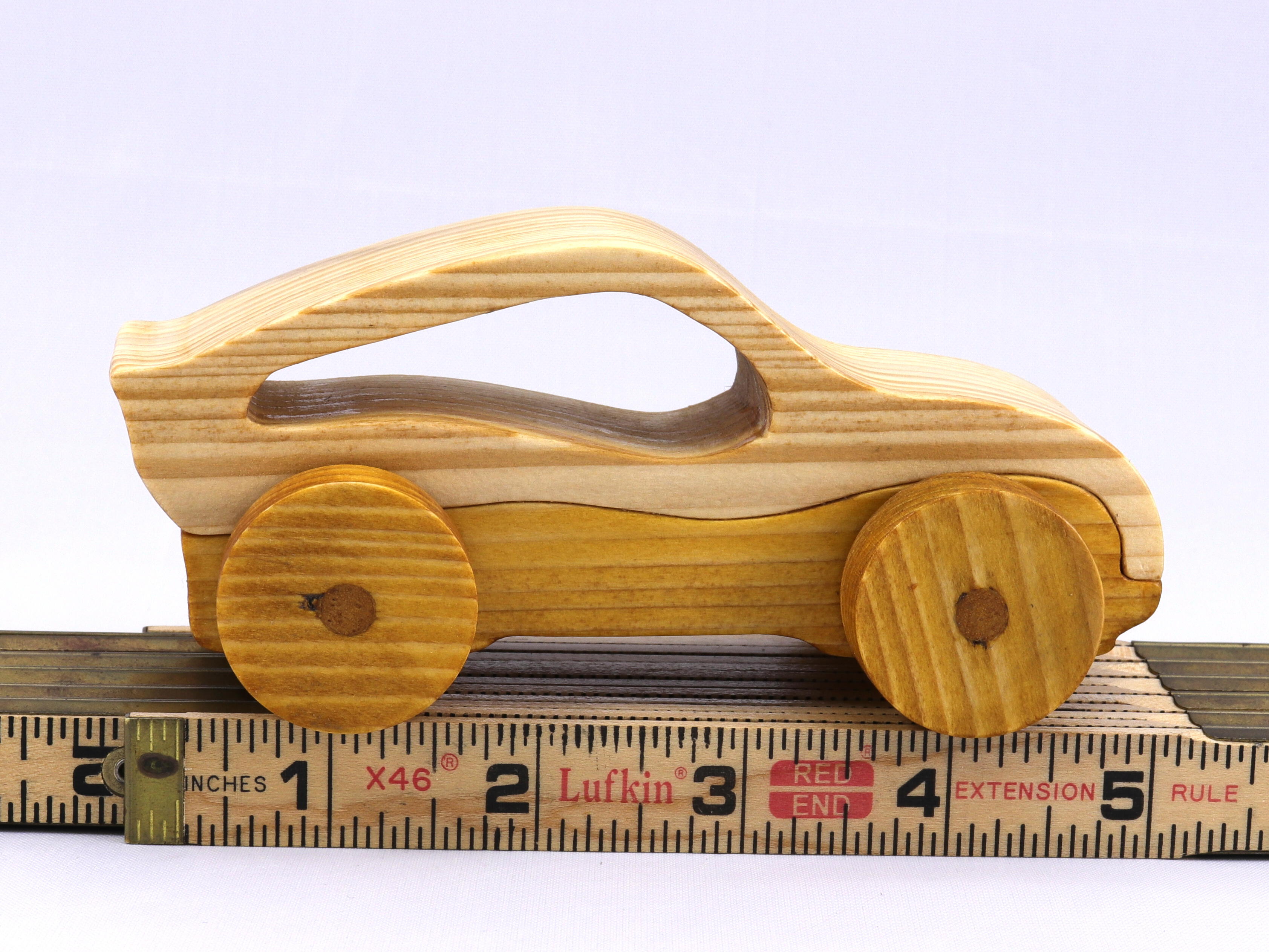 Handmade wooden toy car, two-tone clear and amber shellac finish. Part of my Speedy Wheels Collection.