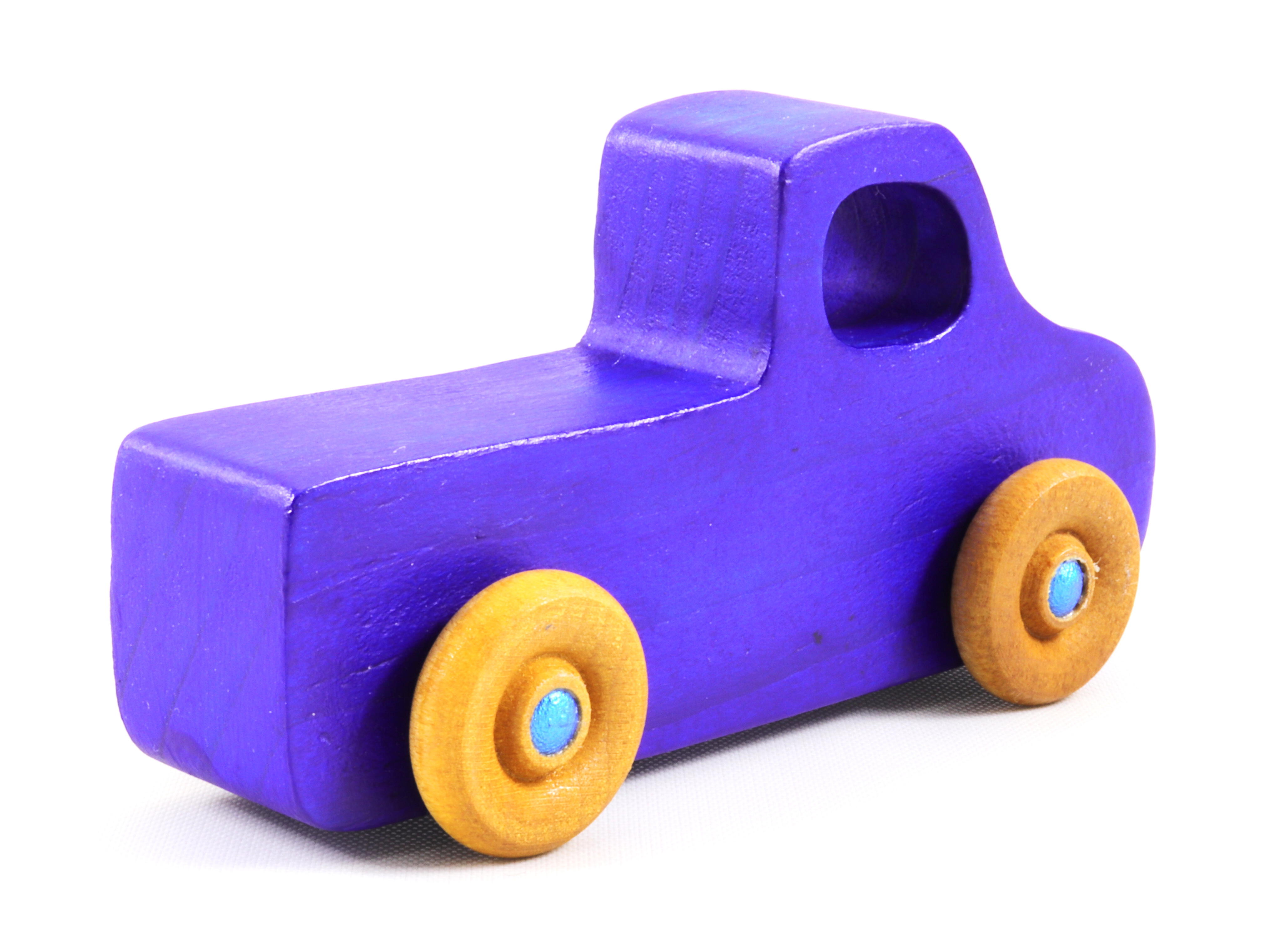 A handmade wooden toy pickup truck painted with bright blue and metallic sapphire blue paint. The wheels are finished with non-marring amber shellac. This toy is part of my Play Pal Collection.