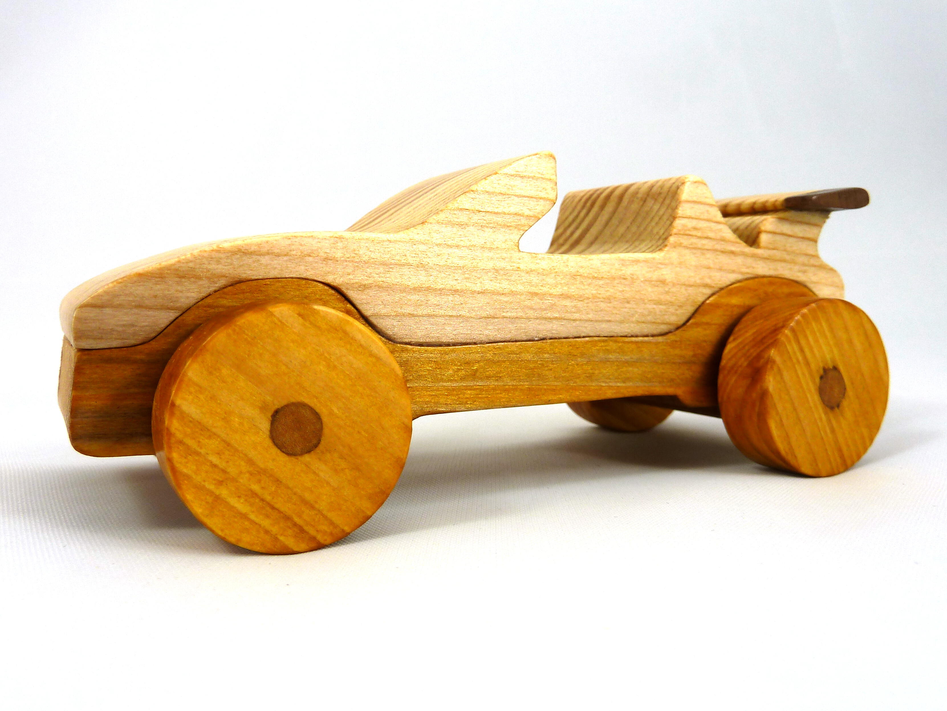 Handmade wooden toy car convertible finished with two-tone clear and amber shellac, one of ten cars in my Speedy Wheels Collection.