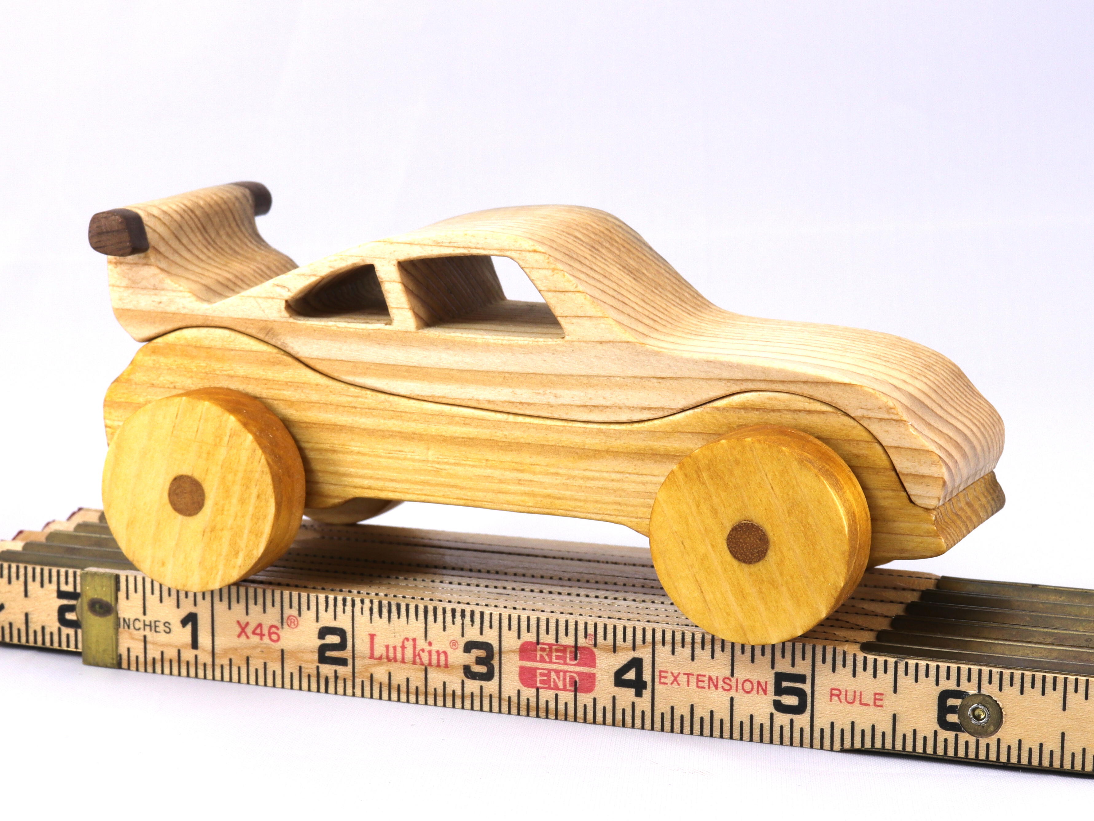 Handmade wooden toy car coupe finished with nontoxic clear, amber shellac and contrasting wood trim. It's one of ten cars in my Speedy Wheels Collection.