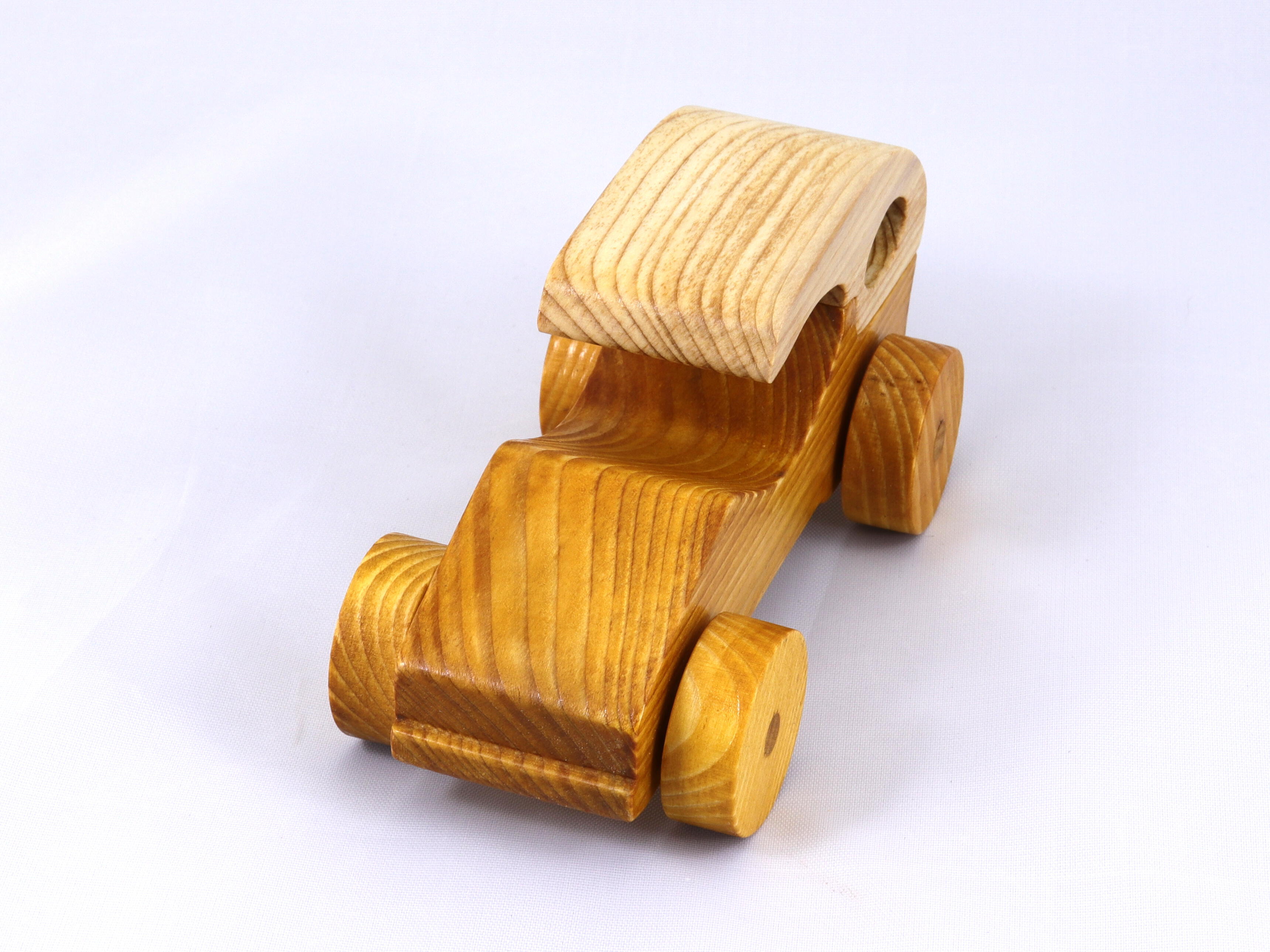Handmade wooden toy car finished with nontoxic clear, amber shellac and contrasting wood trim. It's one of ten cars in my Speedy Wheels Collection.
