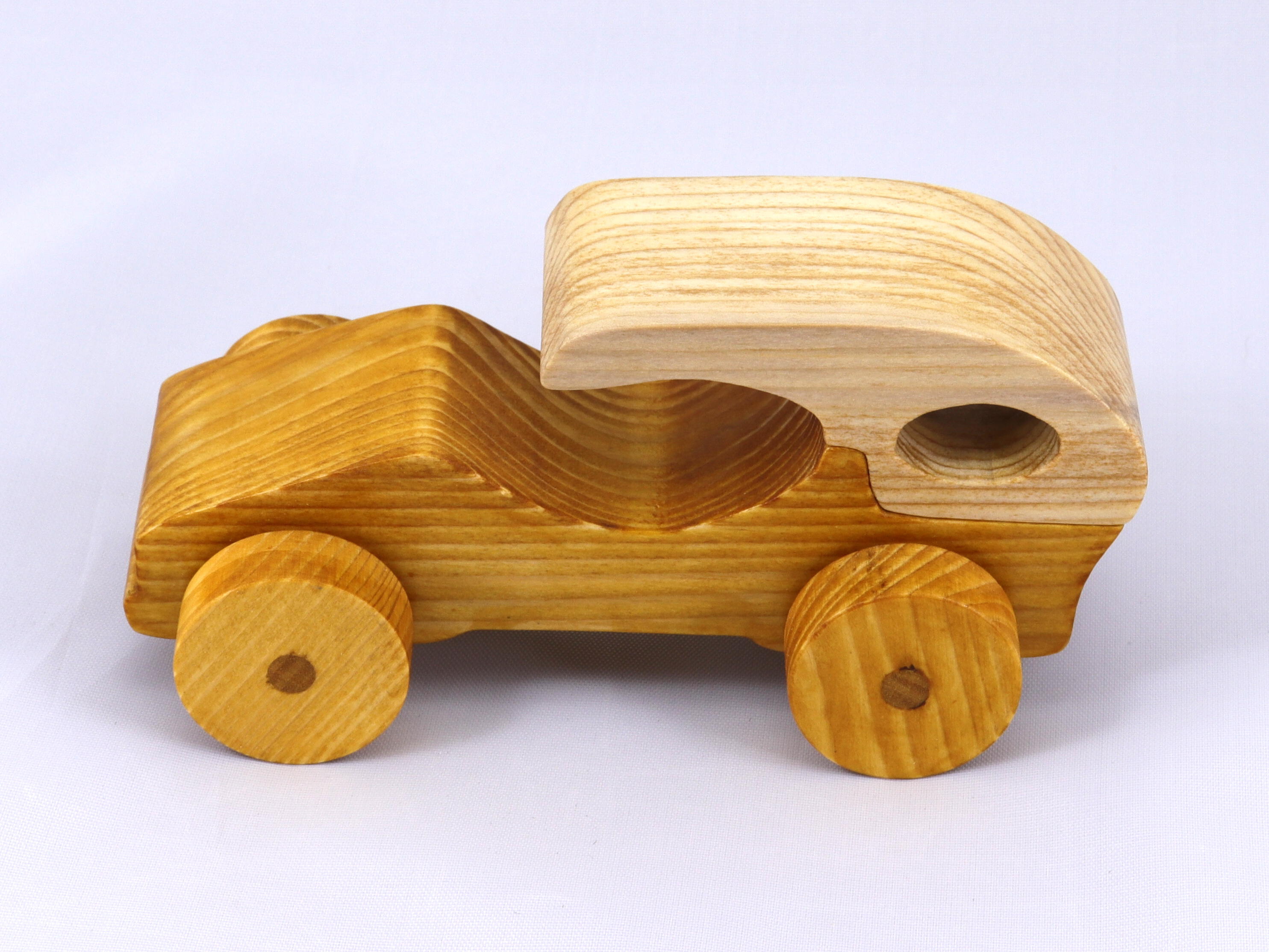 Handmade wooden toy car finished with nontoxic clear, amber shellac and contrasting wood trim. It's one of ten cars in my Speedy Wheels Collection.