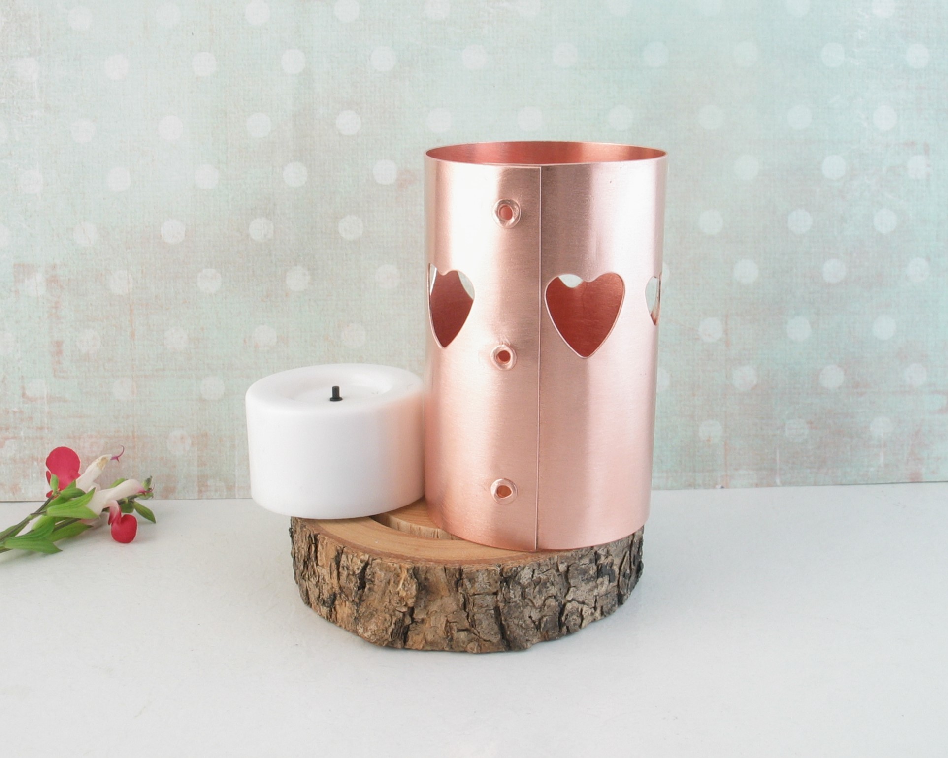 Scandanavian style heart-pierced copper chimney tea light candle holder on live-edge wooden base cut from tree limb. comes with flameless tealight candle.