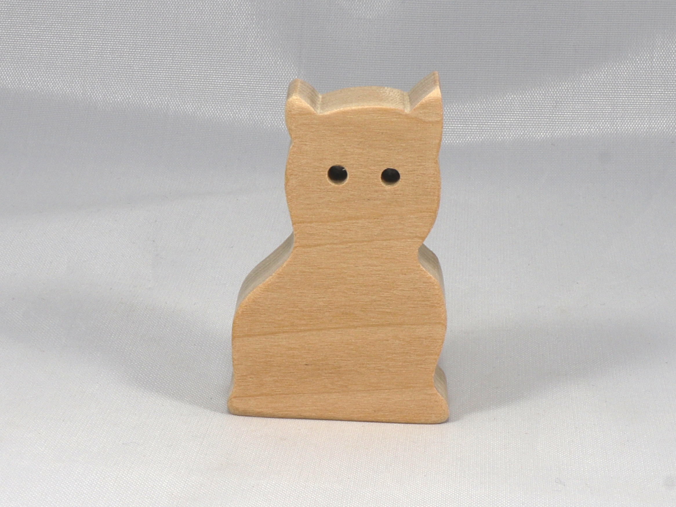 A handmade freestanding wooden toy cat cutout 1/2-3/4 inches thick is made from various kinds of wood sanded smooth and ready to paint. It is excellent for kids' crafts, pretend, or stacking toys. Other sizes are available with a custom order.
