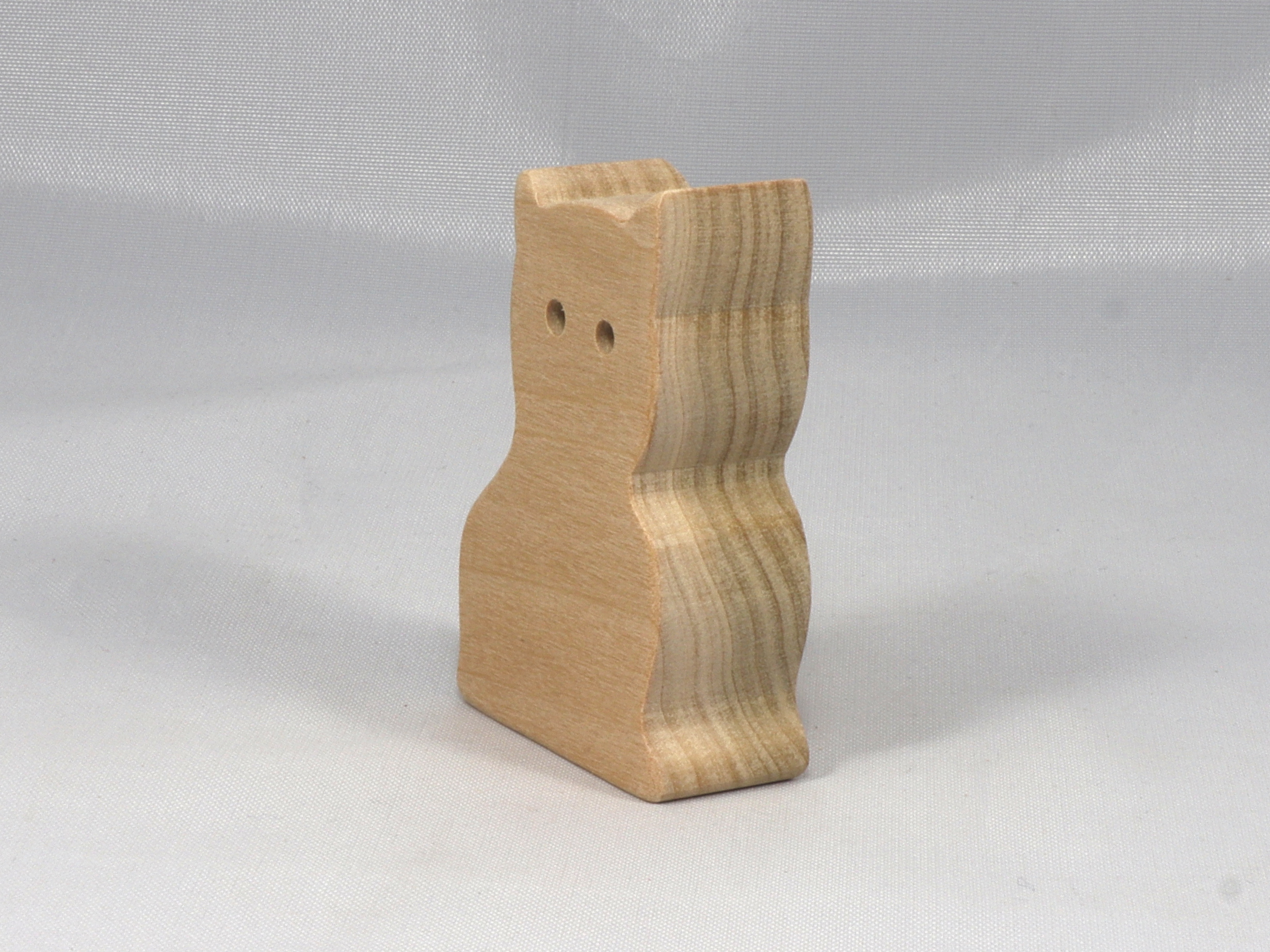 A handmade freestanding wooden toy cat cutout 1/2-3/4 inches thick is made from various kinds of wood sanded smooth and ready to paint. It is excellent for kids' crafts, pretend, or stacking toys. Other sizes are available with a custom order.