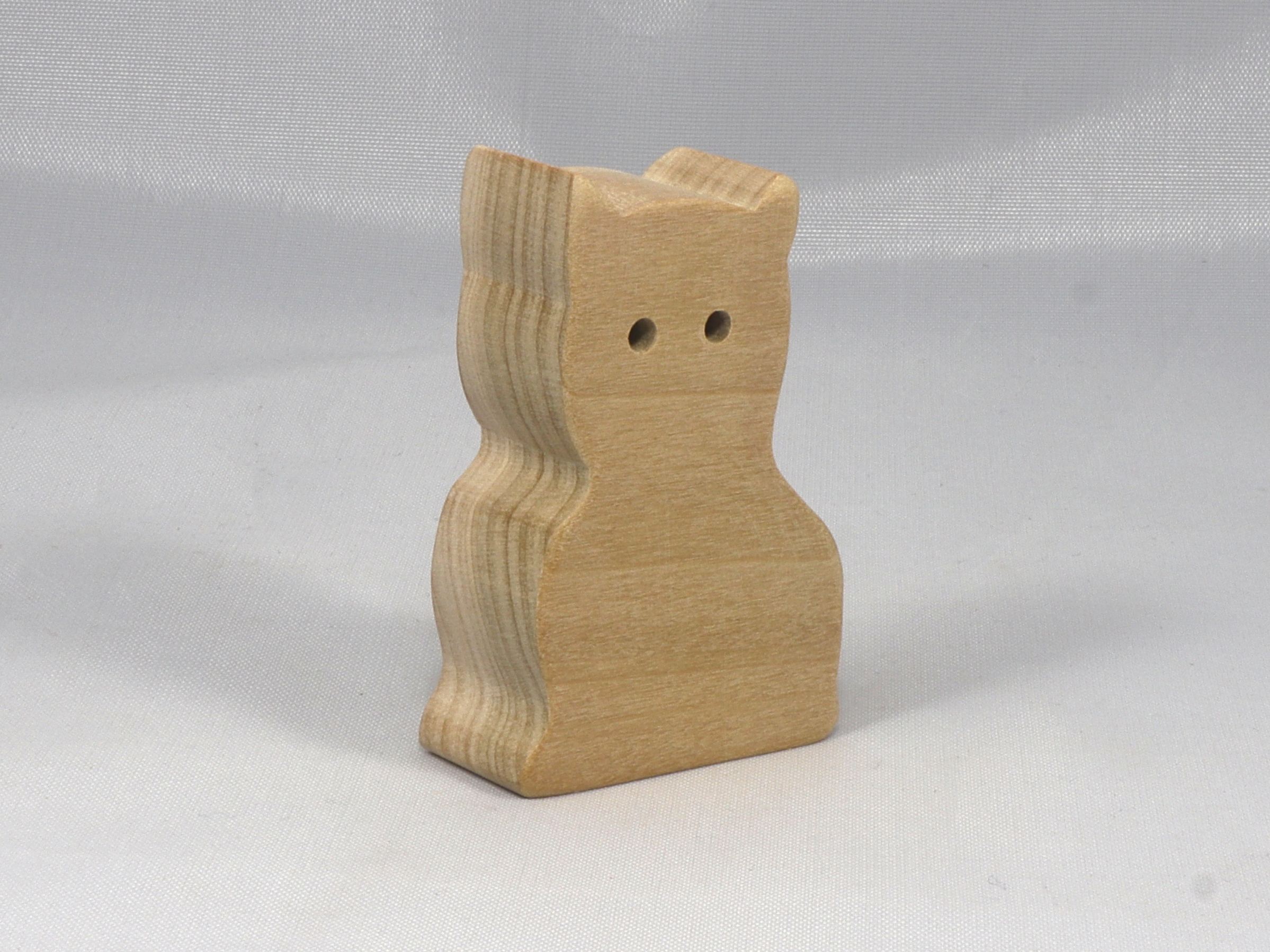 A handmade freestanding wooden toy cat cutout 1/2-3/4 inches thick is made from various kinds of wood sanded smooth and ready to paint. It is excellent for kids' crafts, pretend, or stacking toys. Other sizes are available with a custom order.