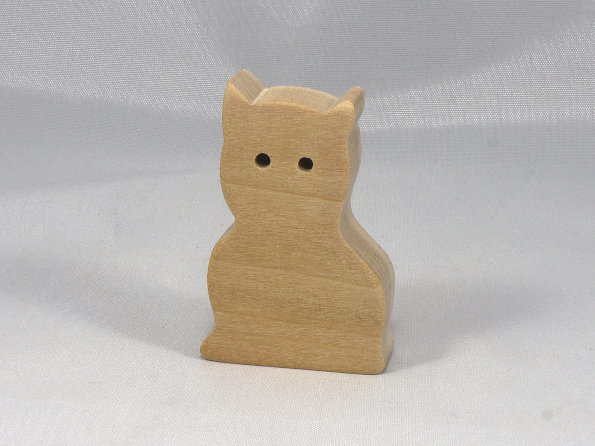 A handmade freestanding wooden toy cat cutout 1/2-3/4 inches thick is made from various kinds of wood sanded smooth and ready to paint. It is excellent for kids' crafts, pretend, or stacking toys. Other sizes are available with a custom order.