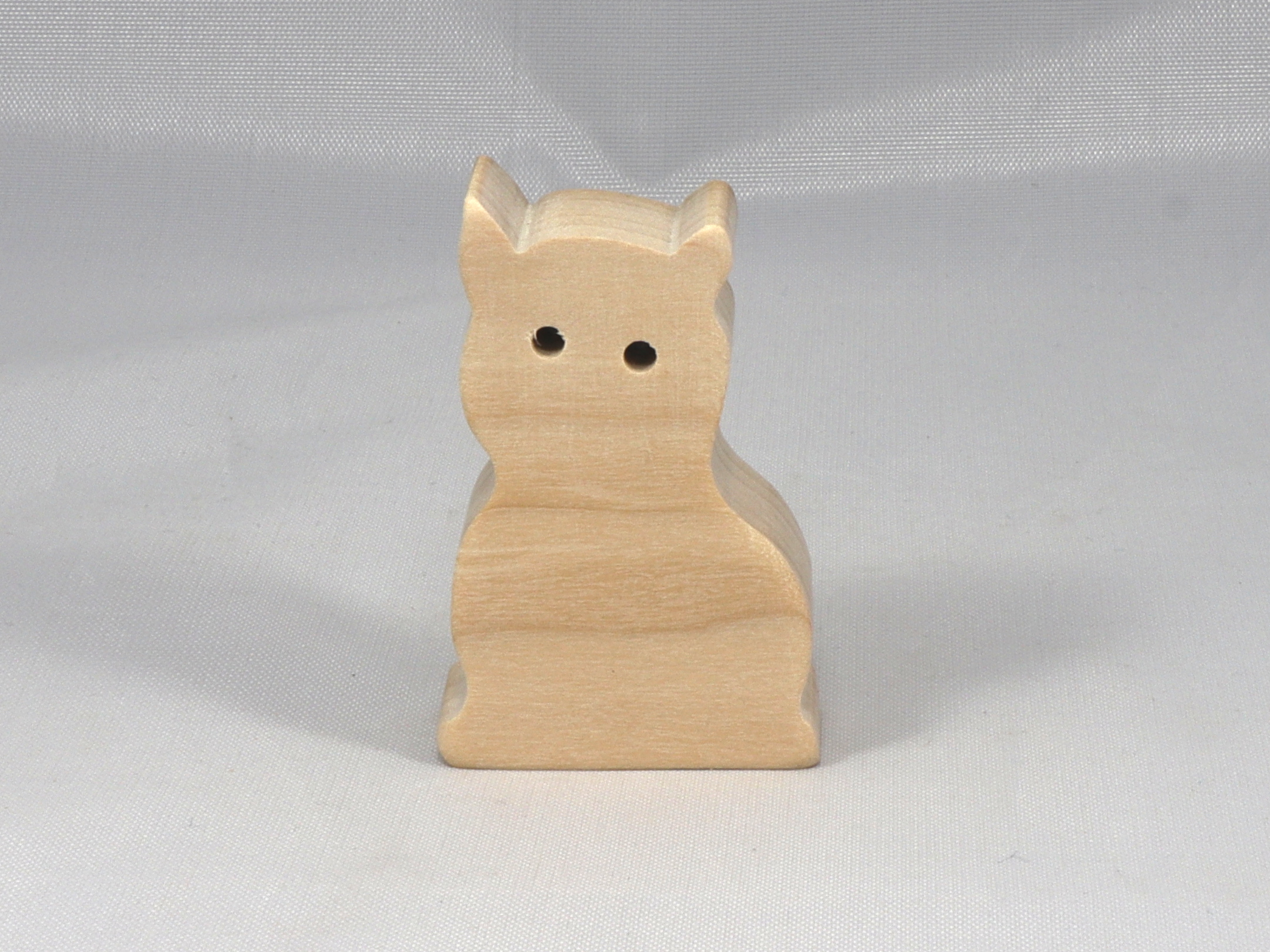 A handmade freestanding wooden toy cat cutout 1/2-3/4 inches thick is made from various kinds of wood sanded smooth and ready to paint. It is excellent for kids' crafts, pretend, or stacking toys. Other sizes are available with a custom order.