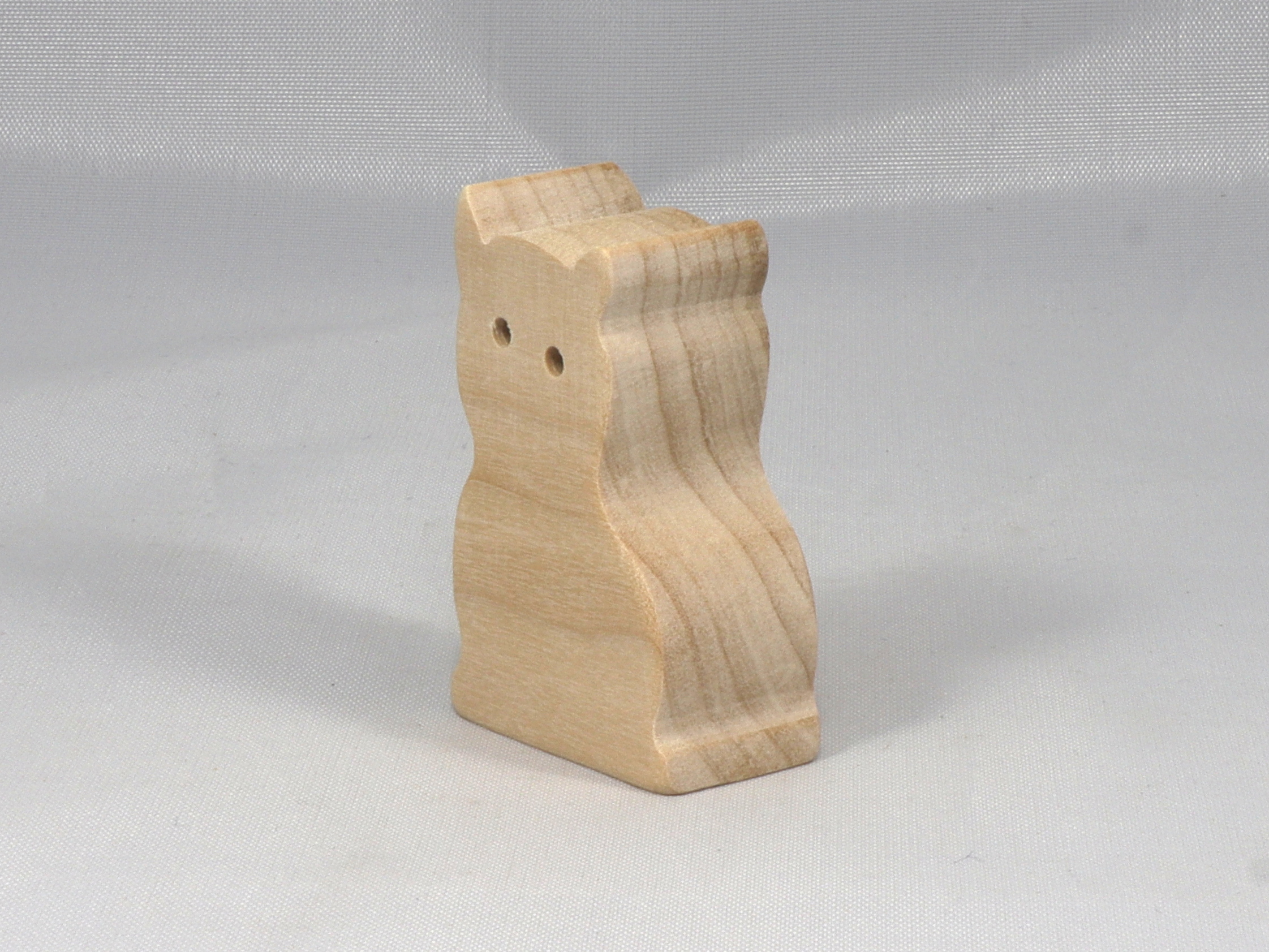 A handmade freestanding wooden toy cat cutout 1/2-3/4 inches thick is made from various kinds of wood sanded smooth and ready to paint. It is excellent for kids' crafts, pretend, or stacking toys. Other sizes are available with a custom order.