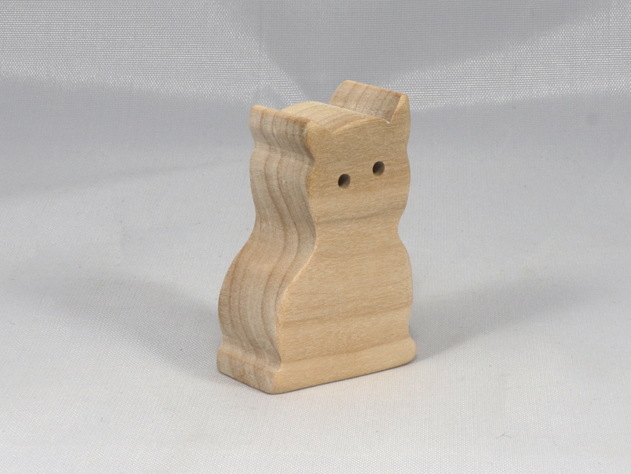 A handmade freestanding wooden toy cat cutout 1/2-3/4 inches thick is made from various kinds of wood sanded smooth and ready to paint. It is excellent for kids' crafts, pretend, or stacking toys. Other sizes are available with a custom order.
