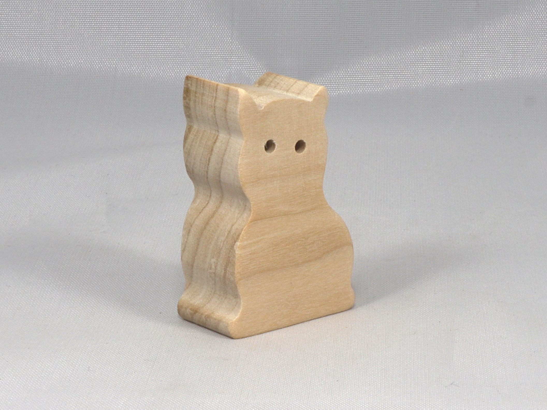 A handmade freestanding wooden toy cat cutout 1/2-3/4 inches thick is made from various kinds of wood sanded smooth and ready to paint. It is excellent for kids' crafts, pretend, or stacking toys. Other sizes are available with a custom order.