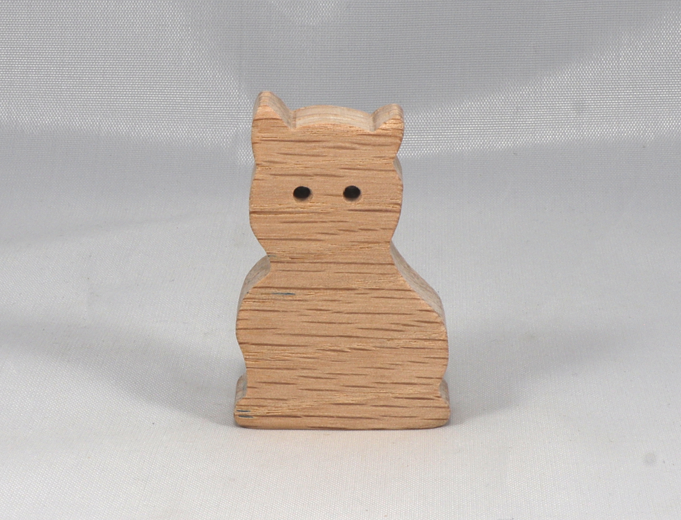 A handmade freestanding wooden toy cat cutout 1/2-3/4 inches thick is made from various kinds of wood sanded smooth and ready to paint. It is excellent for kids' crafts, pretend, or stacking toys. Other sizes are available with a custom order.