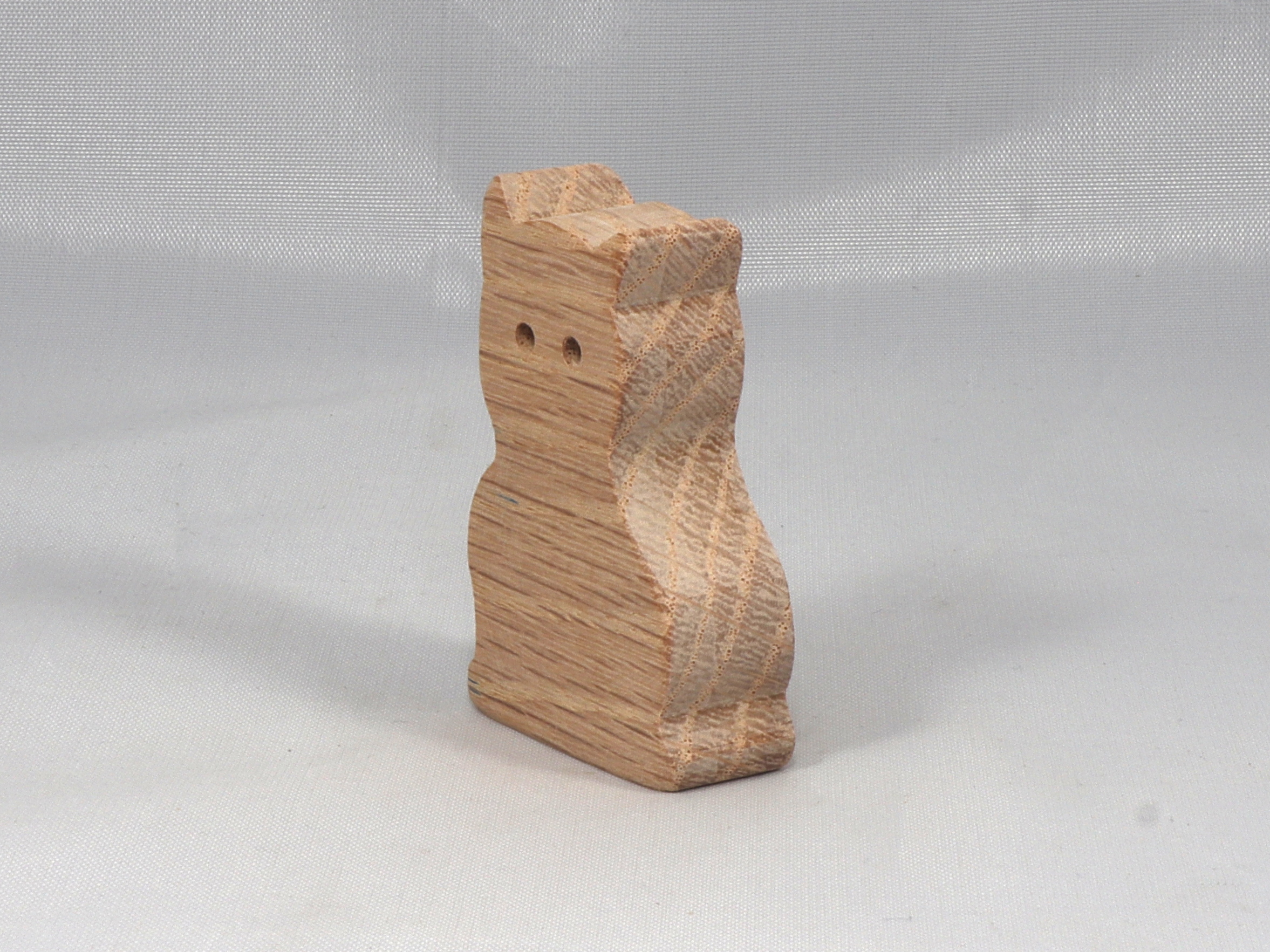A handmade freestanding wooden toy cat cutout 1/2-3/4 inches thick is made from various kinds of wood sanded smooth and ready to paint. It is excellent for kids' crafts, pretend, or stacking toys. Other sizes are available with a custom order.
