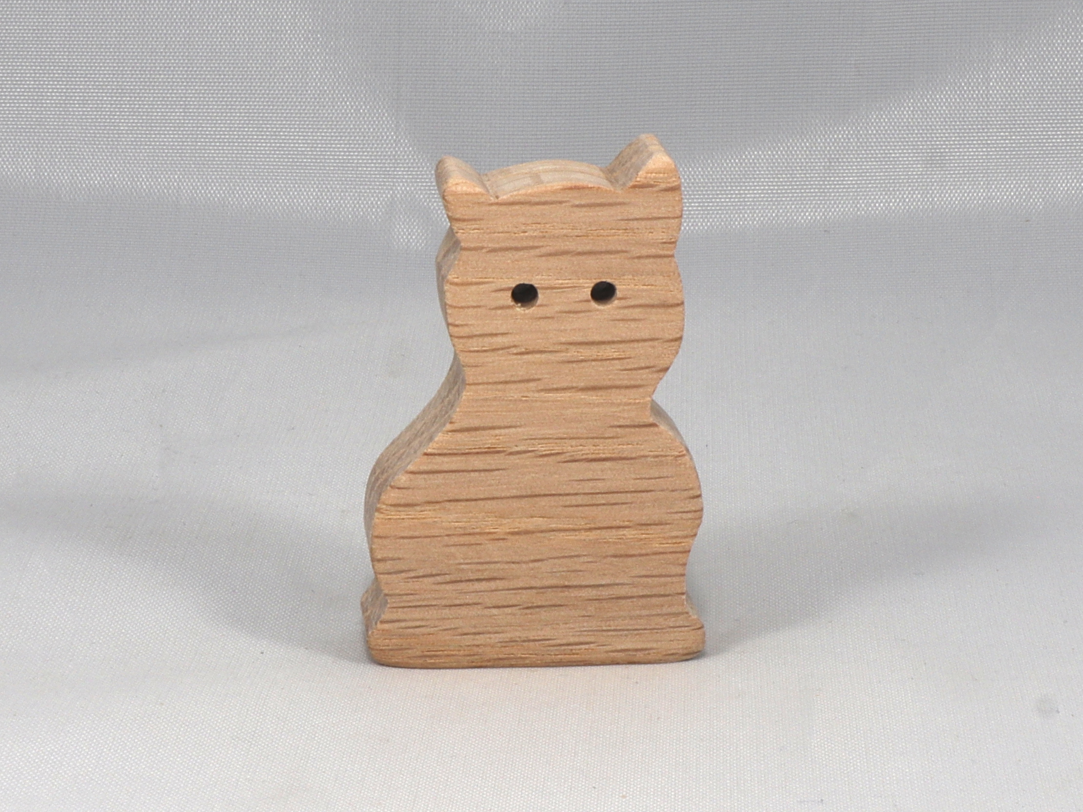 A handmade freestanding wooden toy cat cutout 1/2-3/4 inches thick is made from various kinds of wood sanded smooth and ready to paint. It is excellent for kids' crafts, pretend, or stacking toys. Other sizes are available with a custom order.