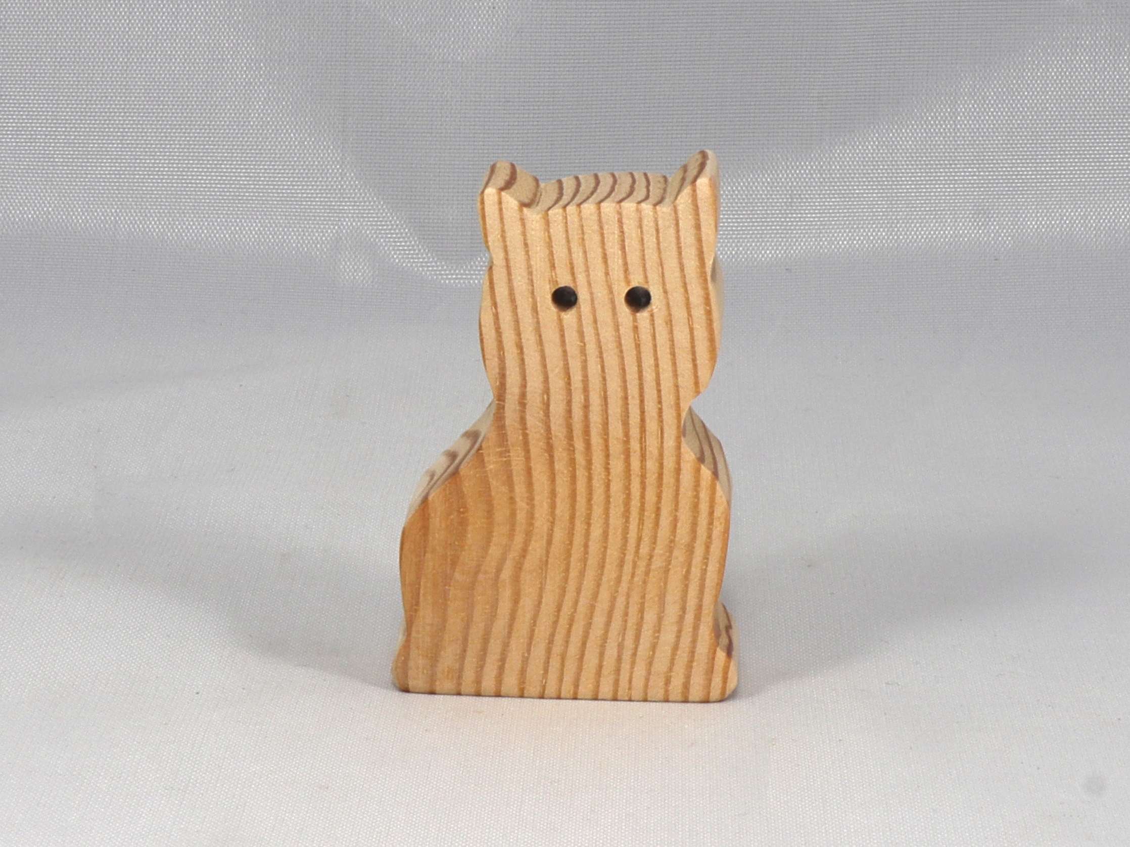 A handmade freestanding wooden toy cat cutout 1/2-3/4 inches thick is made from various kinds of wood sanded smooth and ready to paint. It is excellent for kids' crafts, pretend, or stacking toys. Other sizes are available with a custom order.