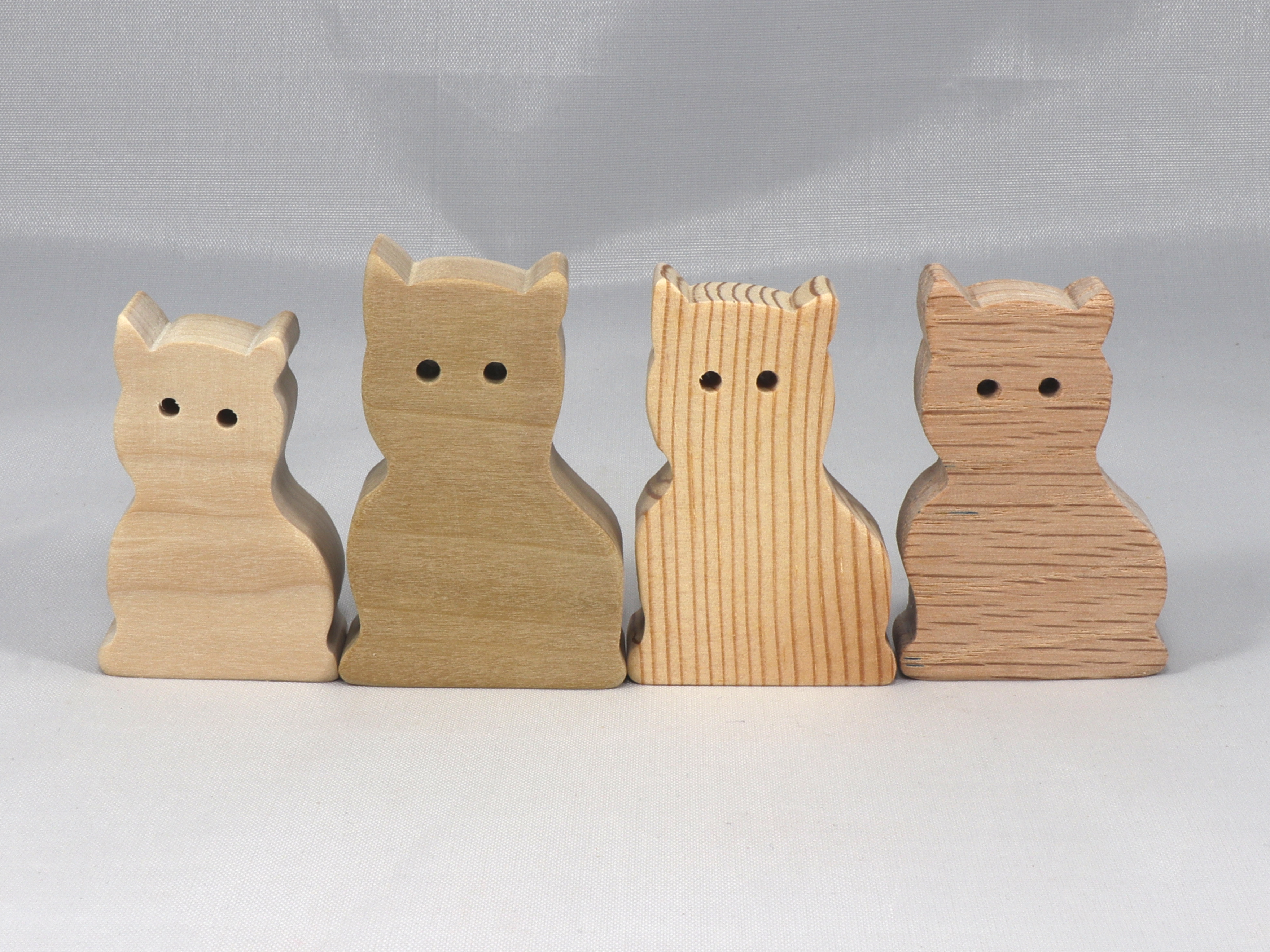 A handmade freestanding wooden toy cat cutout 1/2-3/4 inches thick is made from various kinds of wood sanded smooth and ready to paint. It is excellent for kids' crafts, pretend, or stacking toys. Other sizes are available with a custom order.