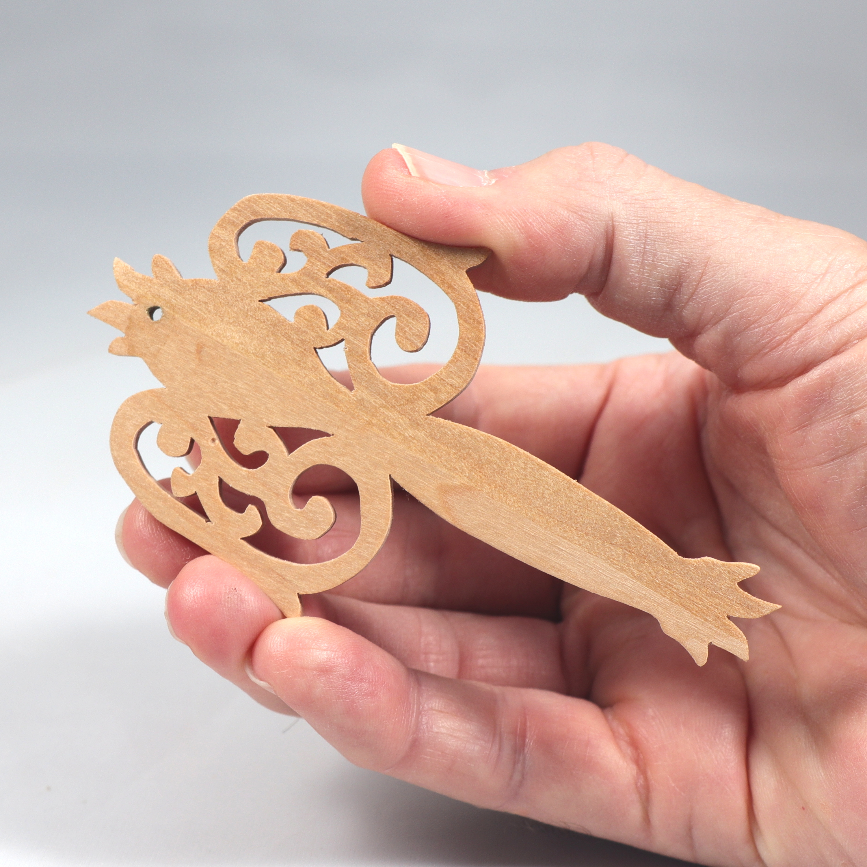 A beautiful handmade wood fretwork Christmas tree ornament in a classic Victorian icicle style. This delicate ornament is hand finished with clear shellac for a timeless look. It is the perfect addition to any Christmas tree collection.