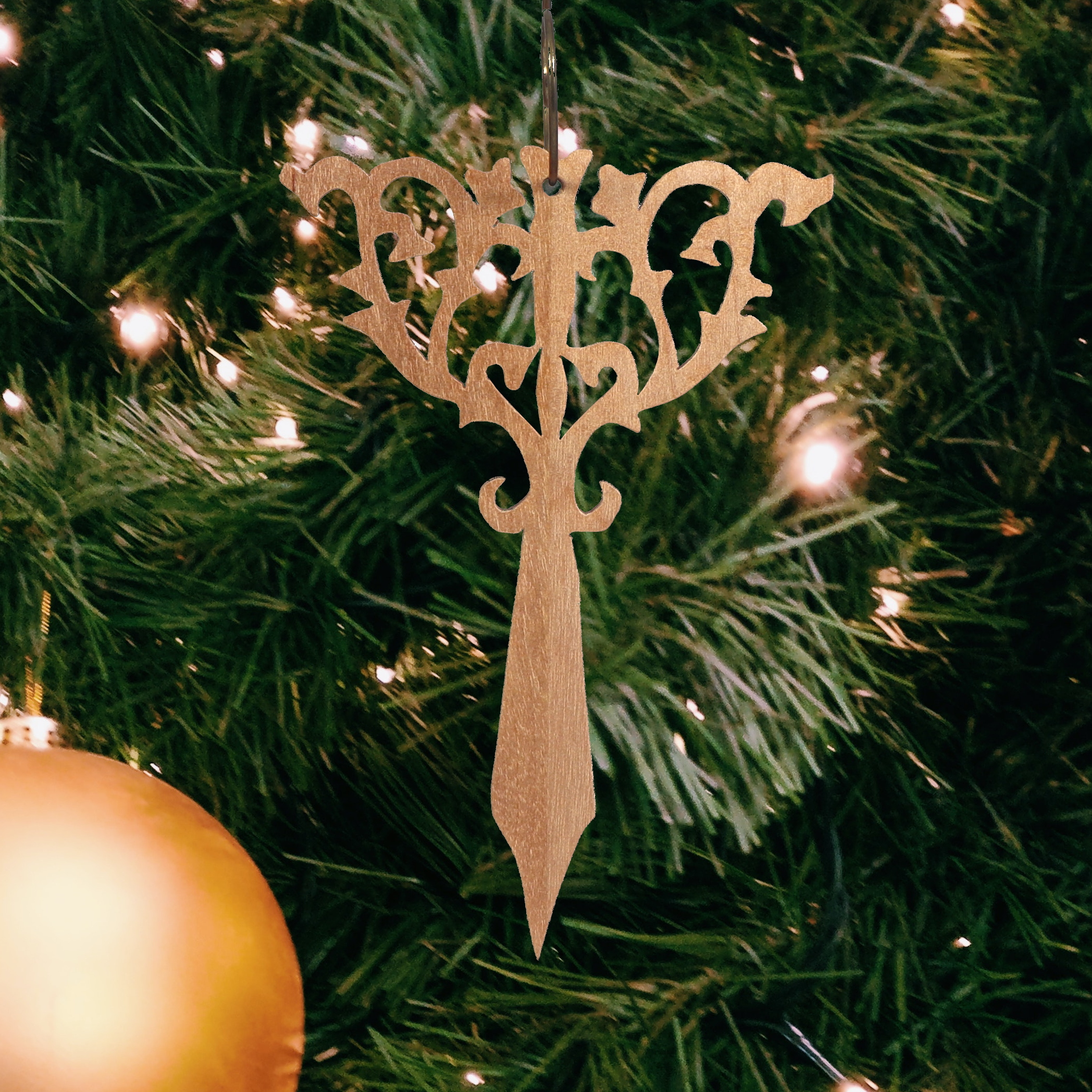 A beautiful handmade wood fretwork Christmas tree ornament in a classic Victorian icicle style. This delicate ornament is hand finished with clear shellac for a timeless look. It is the perfect addition to any Christmas tree collection.