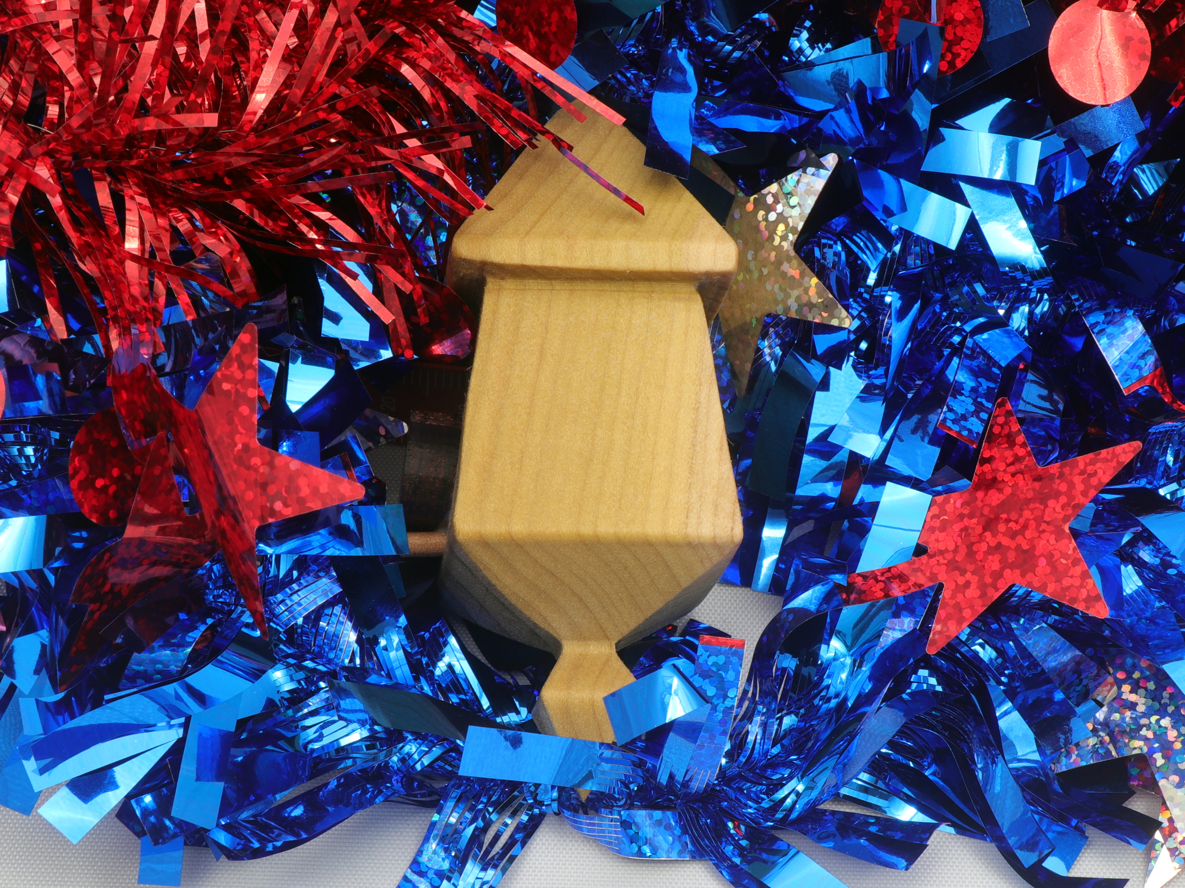Handmade miniature birdhouse ornament crafted from select hardwoods, featuring a meticulous finish with a beeswax and oil blend—a collectible and charming decorative piece.