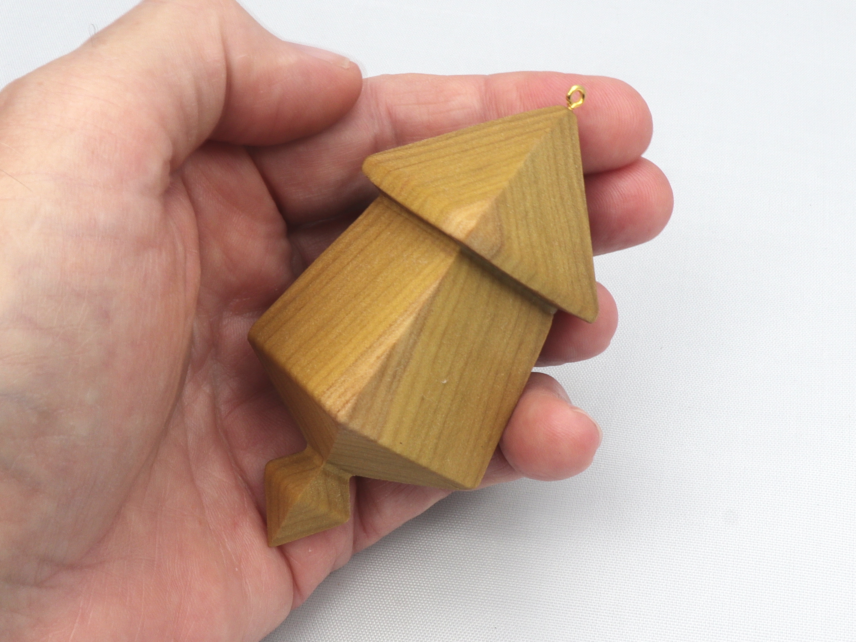 Handmade miniature birdhouse ornament crafted from select hardwoods, featuring a meticulous finish with a beeswax and oil blend—a collectible and charming decorative piece.