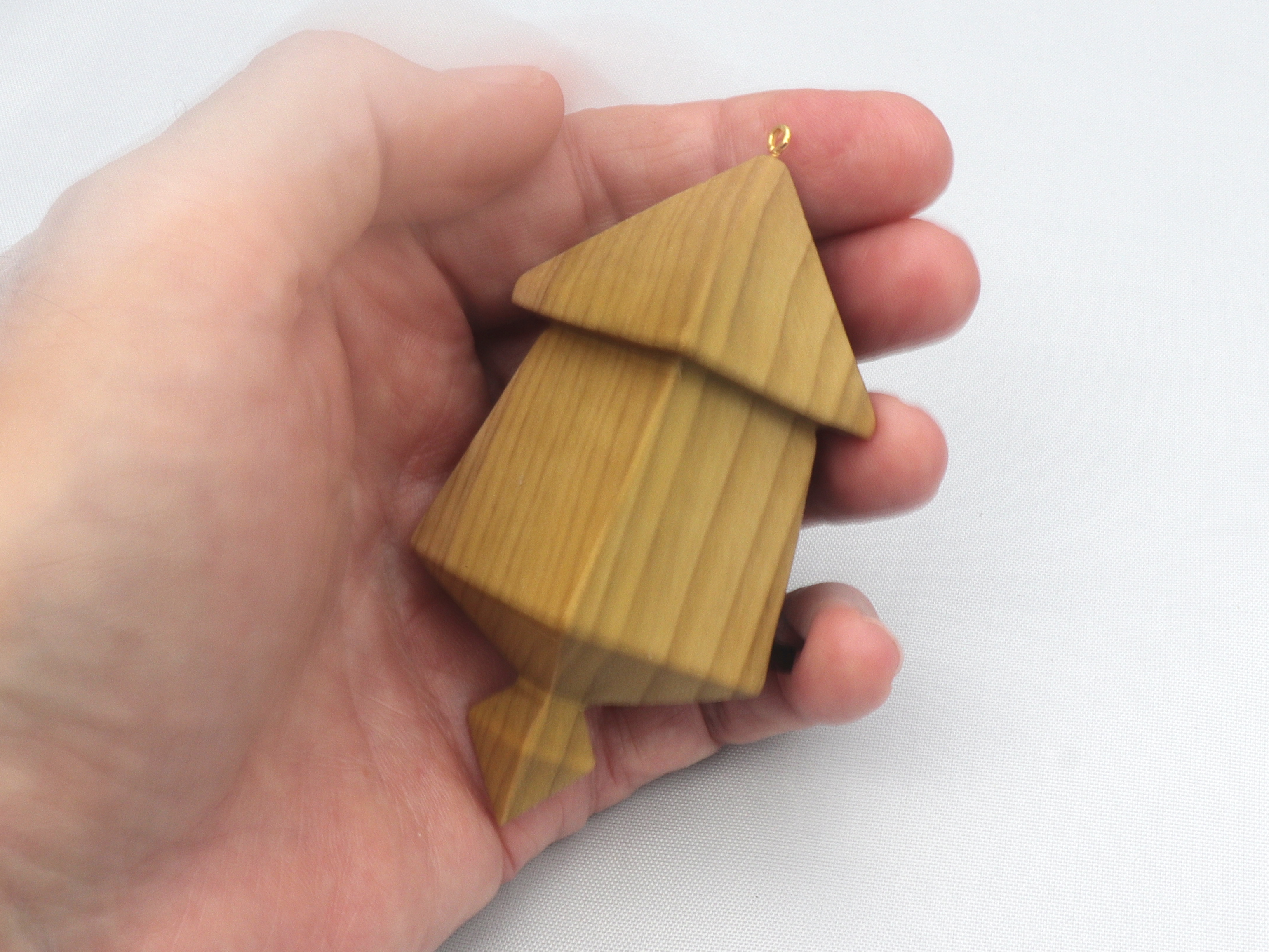 Handmade miniature birdhouse ornament crafted from select hardwoods, featuring a meticulous finish with a beeswax and oil blend—a collectible and charming decorative piece.