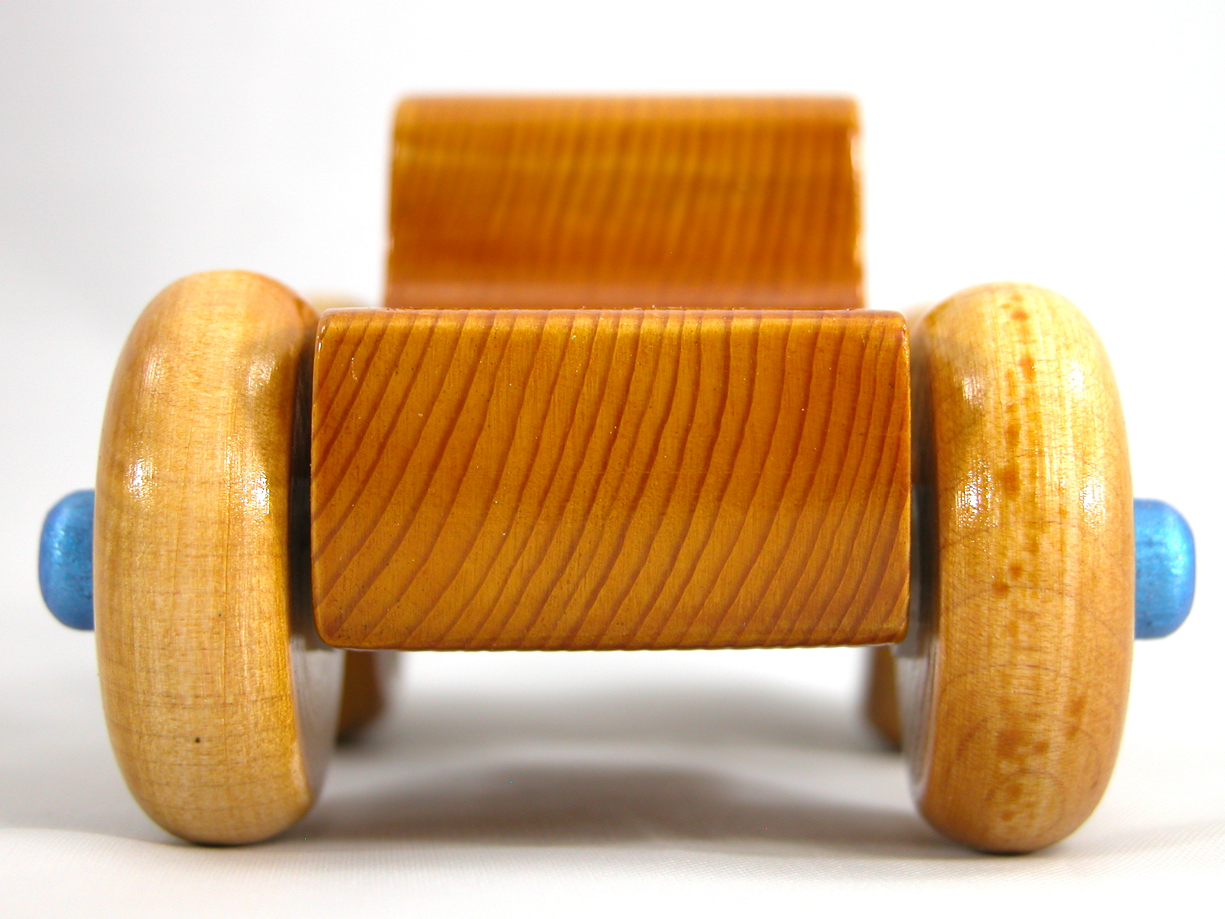 Handmade Wooden Toy Truck With Round Windows Finished with Glossy Amber Shellac and Metallic Sapphire Blue Acrylic Paint trim. Excellent, durable push toy for toddlers with chunky wheels that roll well on any surface.