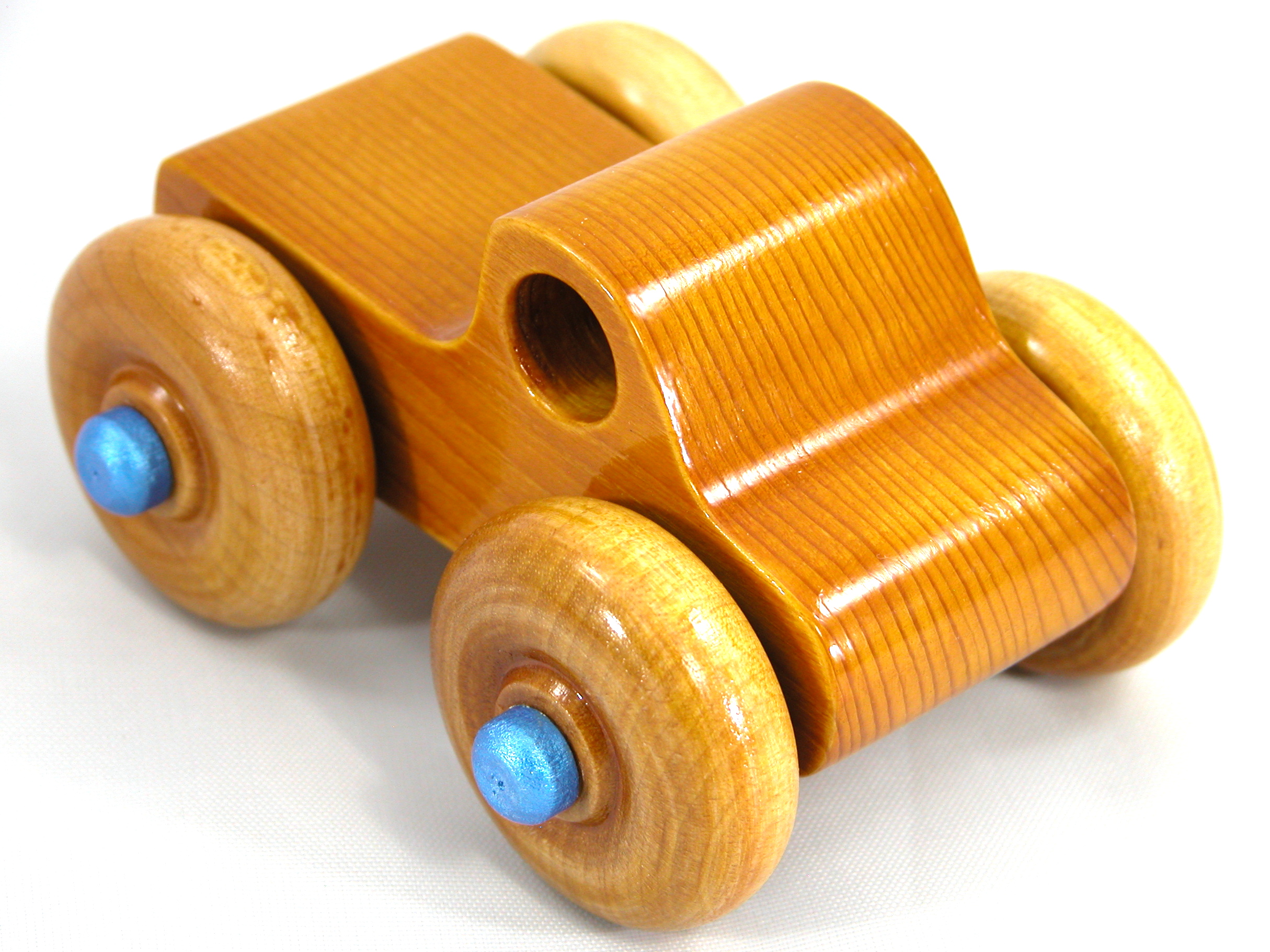 Handmade Wooden Toy Truck With Round Windows Finished with Glossy Amber Shellac and Metallic Sapphire Blue Acrylic Paint trim. Excellent, durable push toy for toddlers with chunky wheels that roll well on any surface.