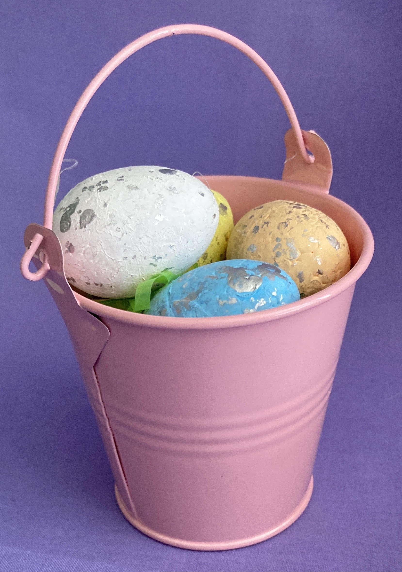 Metal pail with eggs.