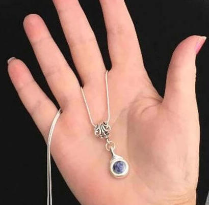Beautiful Blue Jasper stone is viewed on a flute trill key.  A fleur de lis bail on a  16" silver plated snake chain.