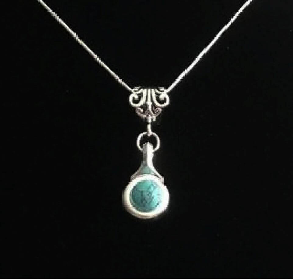 Beautiful Howlite stone is viewed on a flute trill key.  A fleur de lis bail on a  16" silver plated snake chain.
