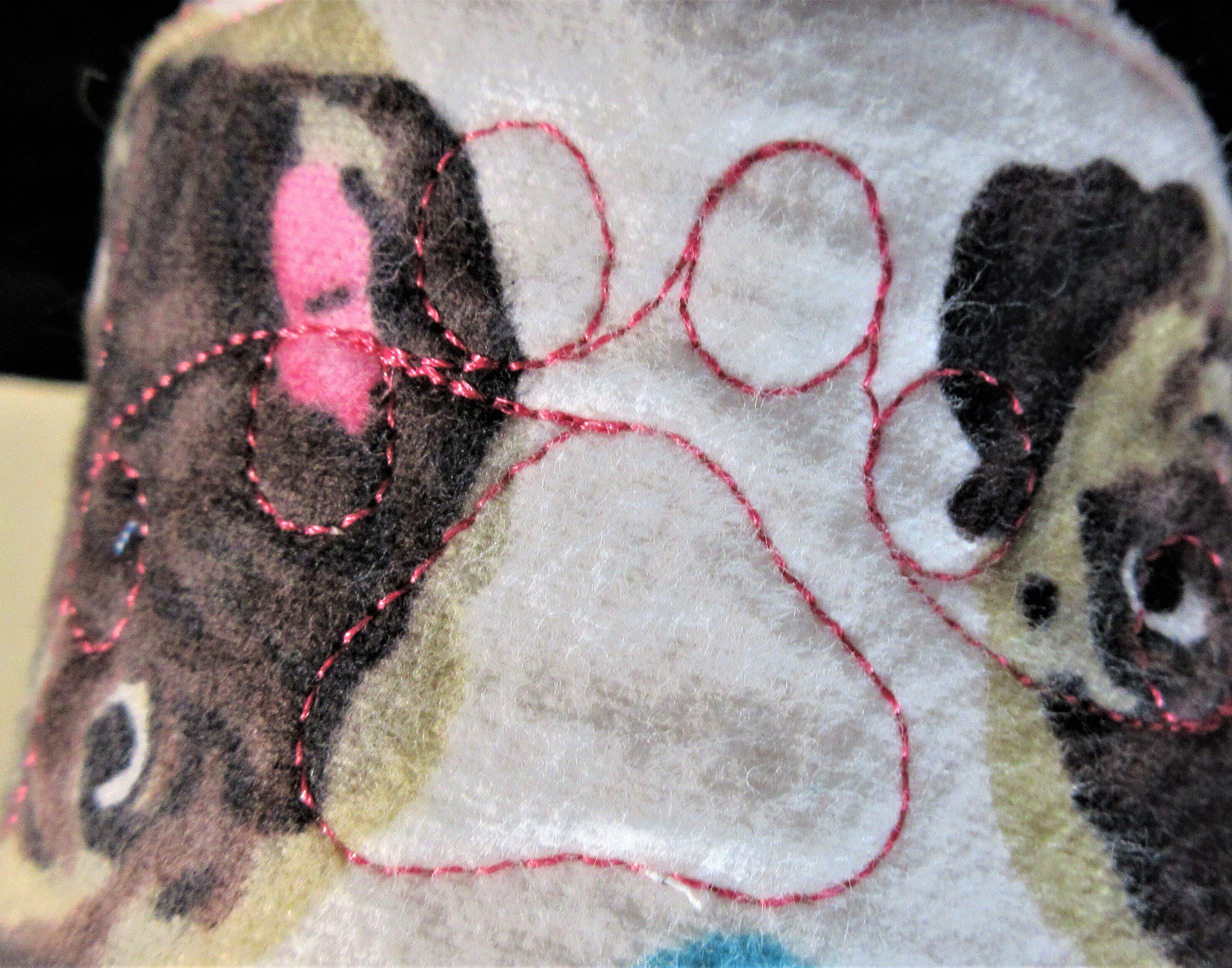 embroidered paw print on drink sleeve with coffee print and kittens and puppies