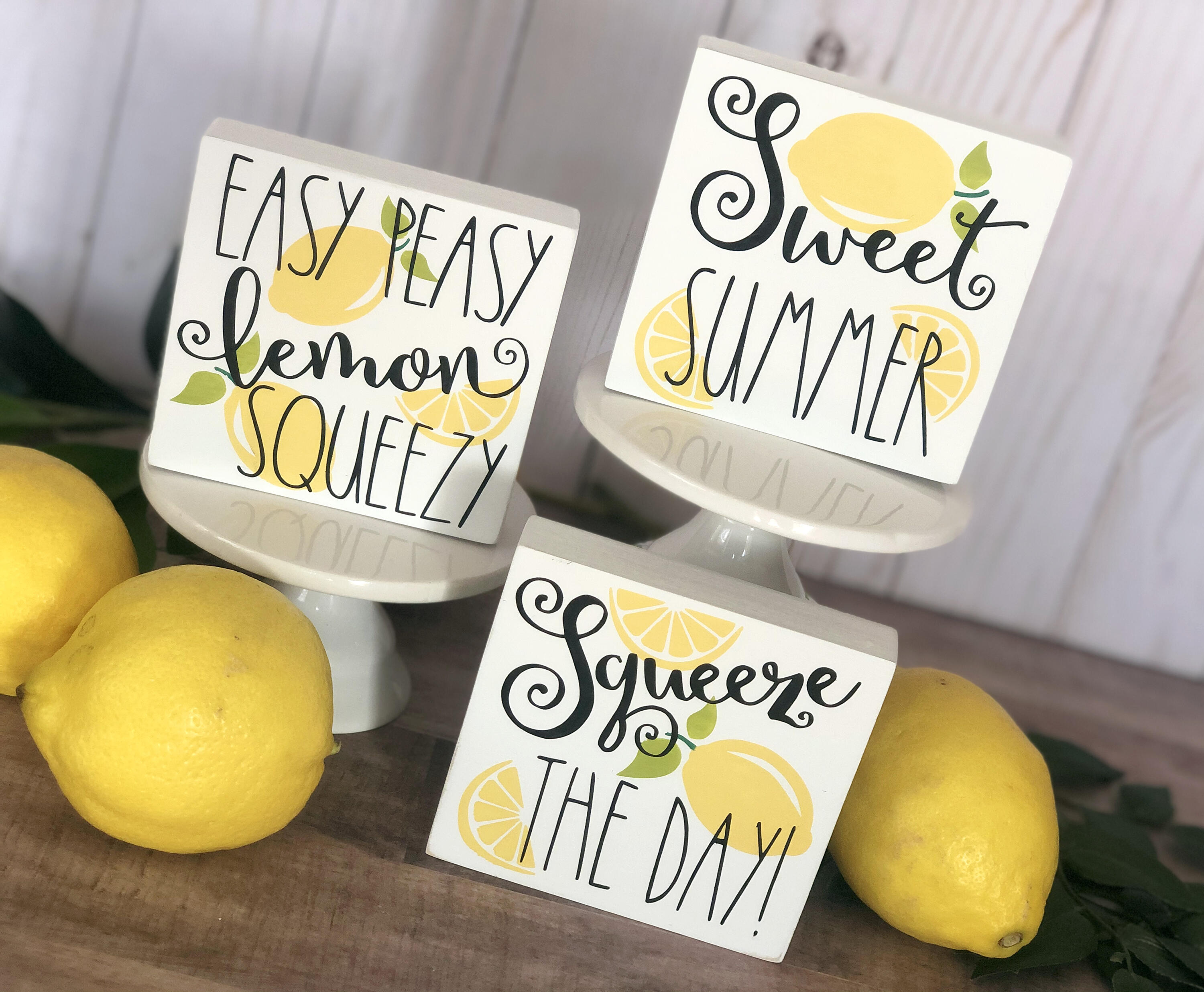 Summer Lemon Signs, Lemon Quotes on painted white wood with bright yellow lemons with green leaves and lemon slices, and a whimsical font.