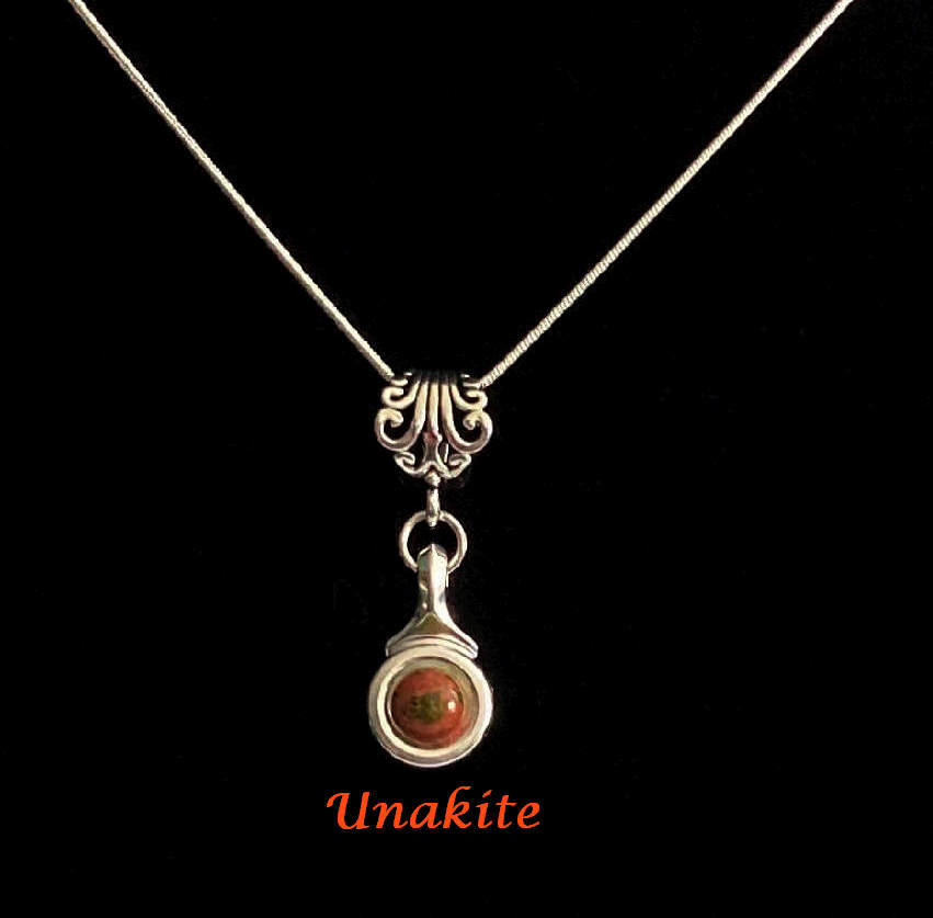 Beautiful Unakite stone is viewed on a flute trill key.  A fleur de lis bail on a  16" silver plated snake chain.