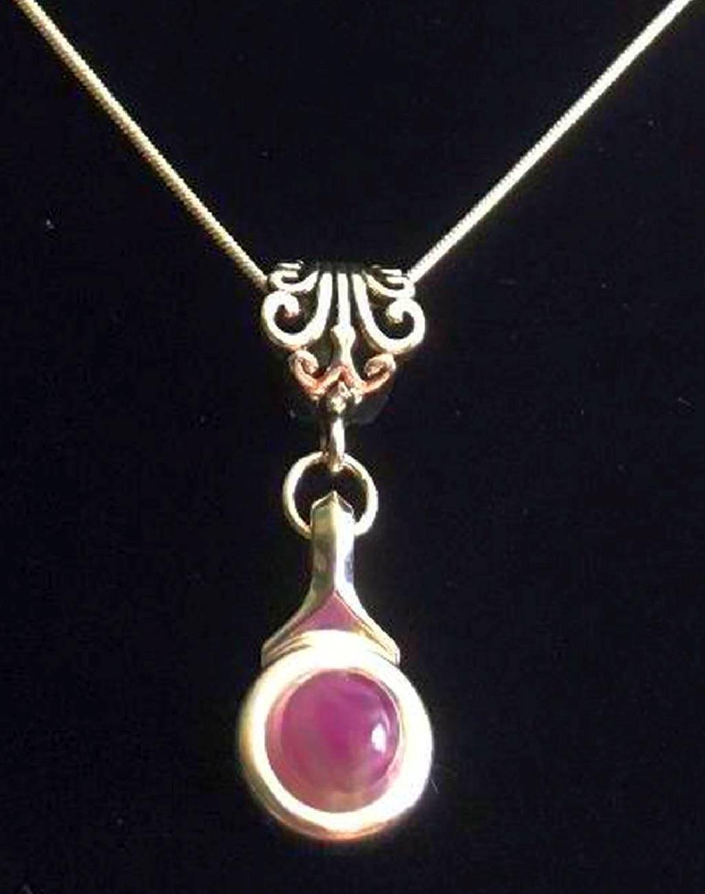 Beautiful Amethyst stone is viewed on a flute trill key.  A fleur de lis bail on a  16" silver plated snake chain.