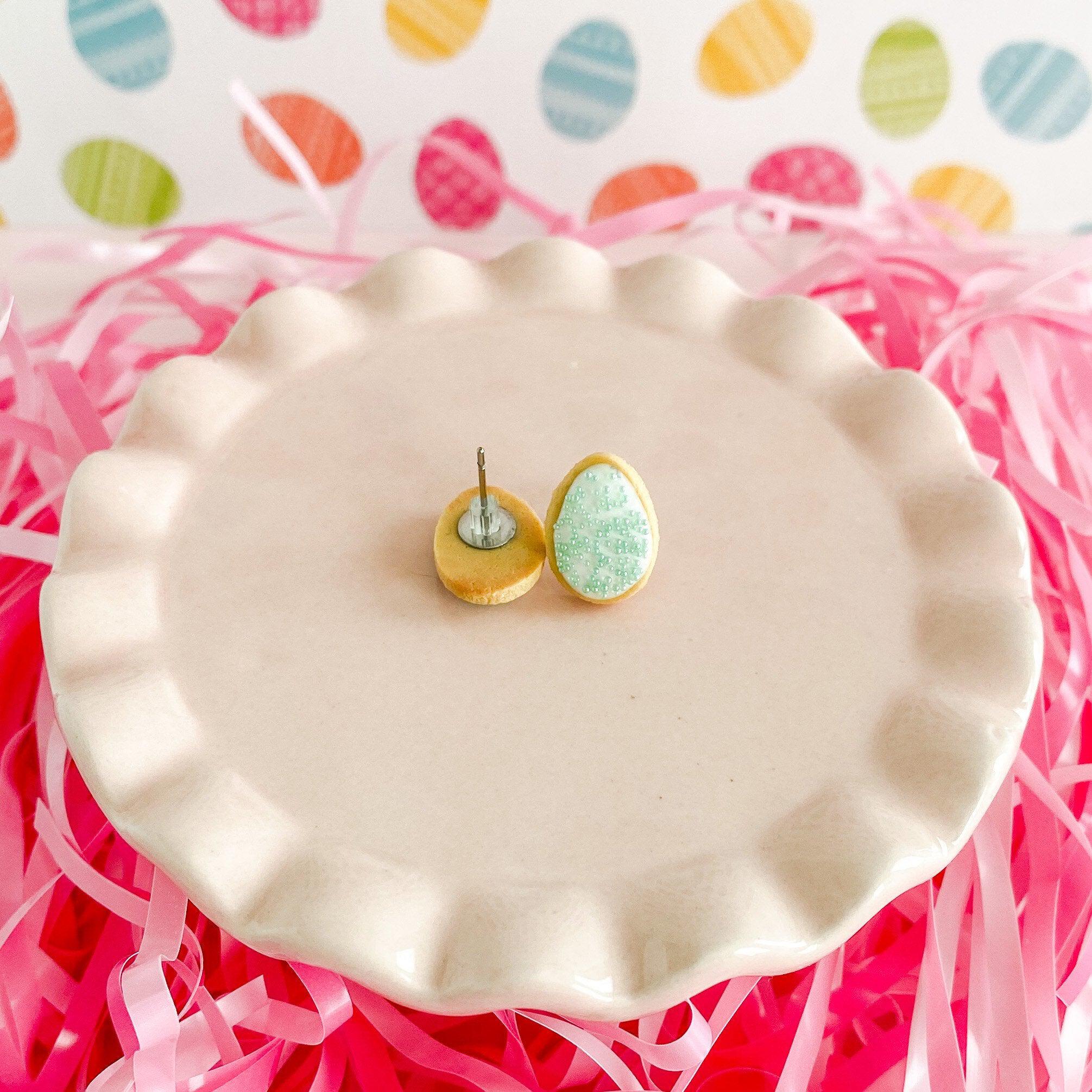 fireflyFrippery Mint Green Easter Egg Sugar Cookie Earrings on Pink Display - Front & Back