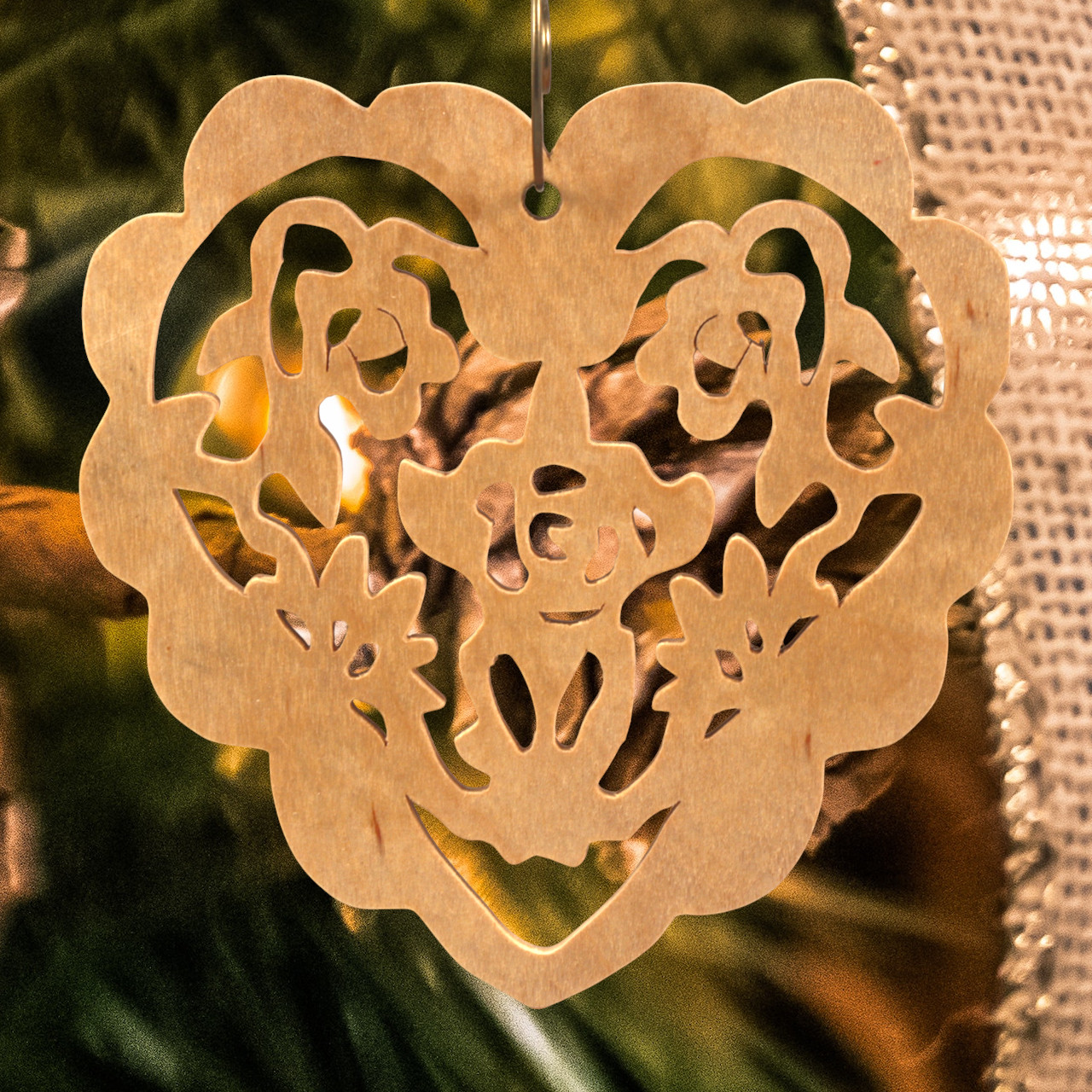 A handmade wooden Victorian-style fretwork floral heart Christmas tree ornament, featuring intricate cutout floral patterns in a heart shape, with a warm natural wood finish.