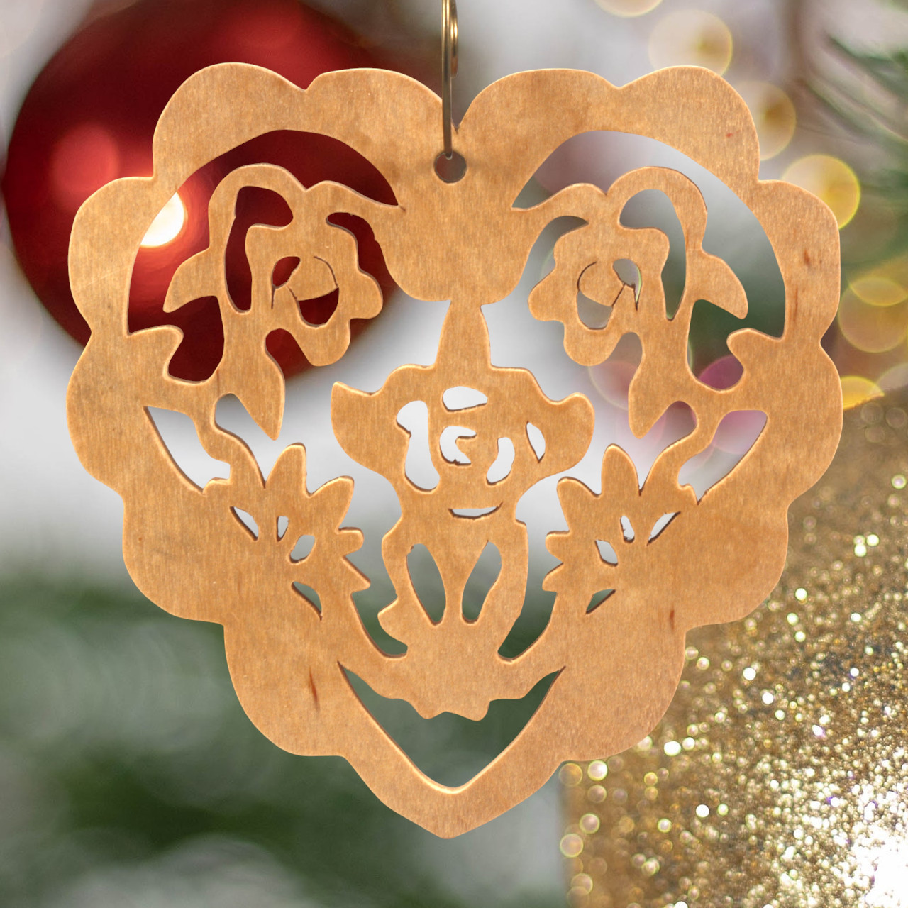 A handmade wooden Victorian-style fretwork floral heart Christmas tree ornament, featuring intricate cutout floral patterns in a heart shape, with a warm natural wood finish.