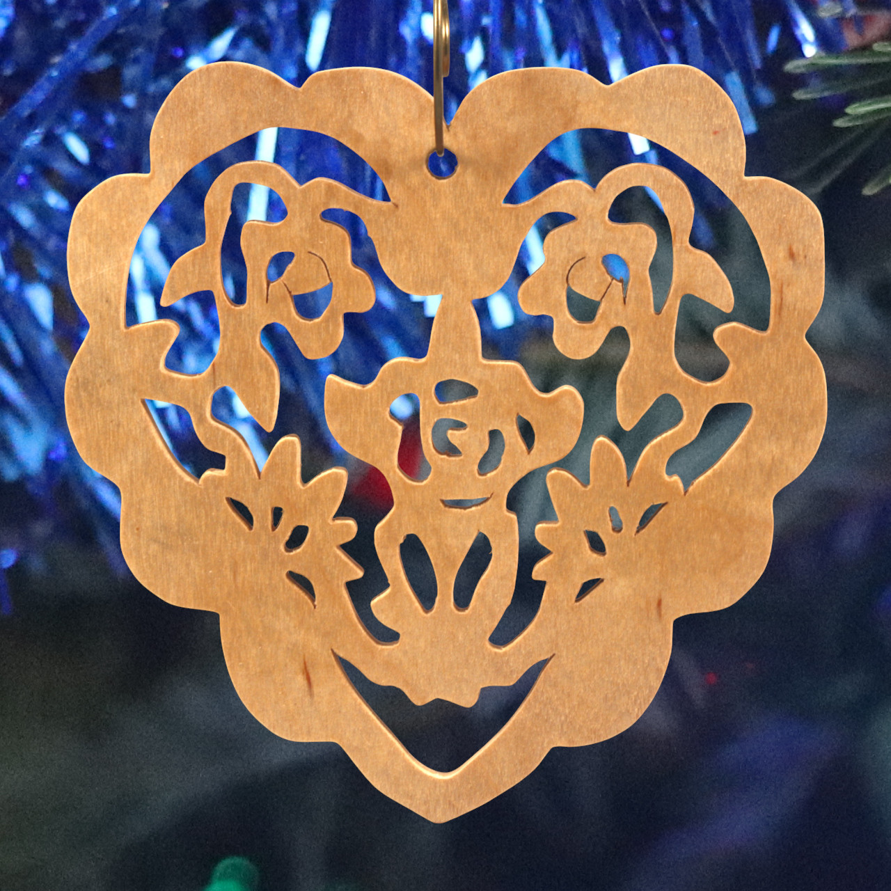 A handmade wooden Victorian-style fretwork floral heart Christmas tree ornament, featuring intricate cutout floral patterns in a heart shape, with a warm natural wood finish.